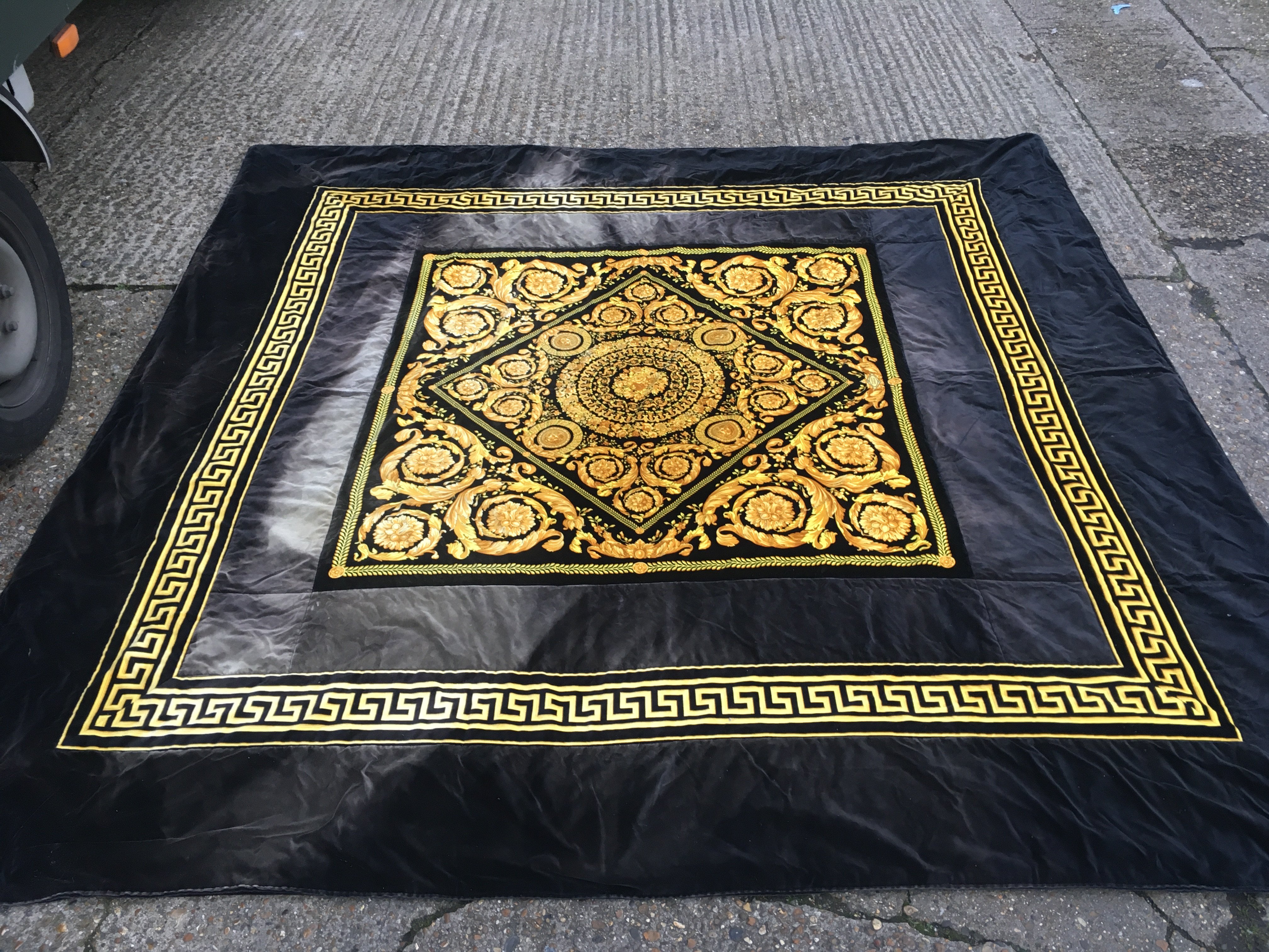 A Versace home collection black and gold floral design 100% polyester rug . Made in Italy. dimensions 258x258cm