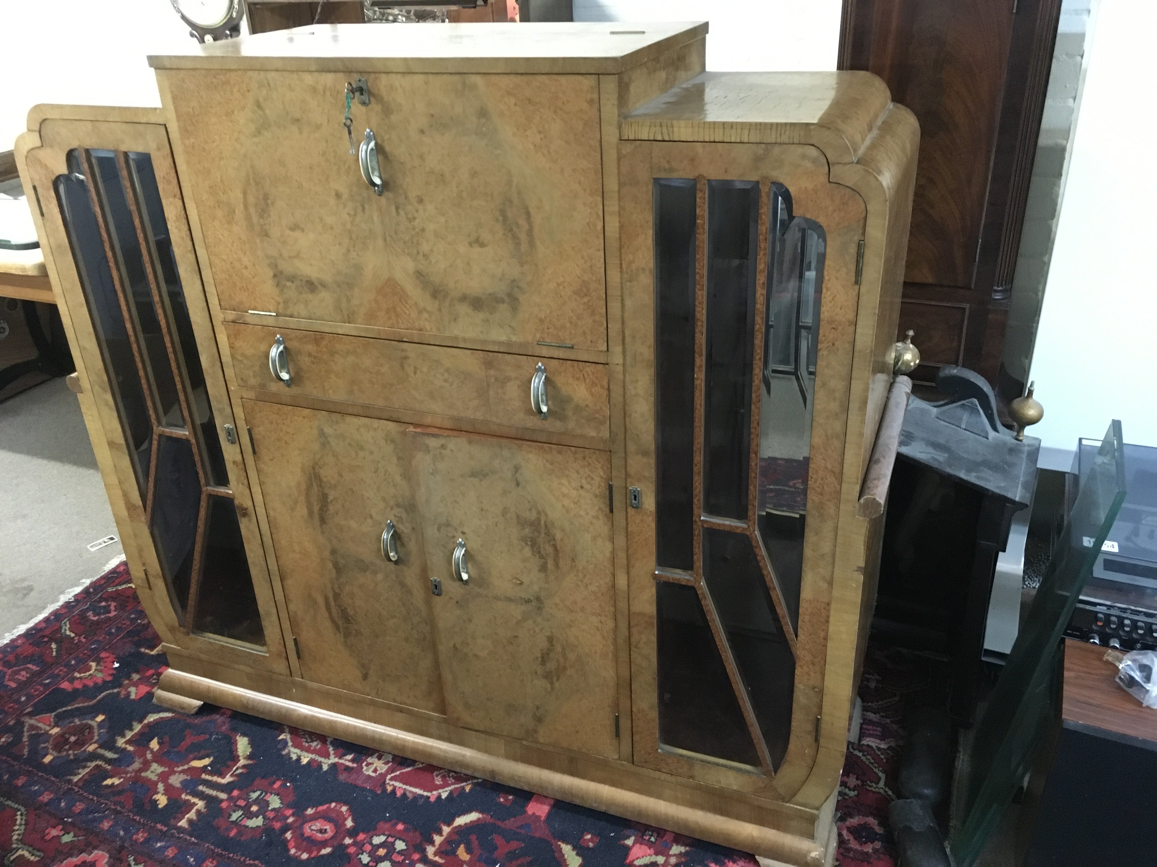 An Art Deco cocktail cabinet, approx 135cm x 44cm x 127cm. Shipping category D.