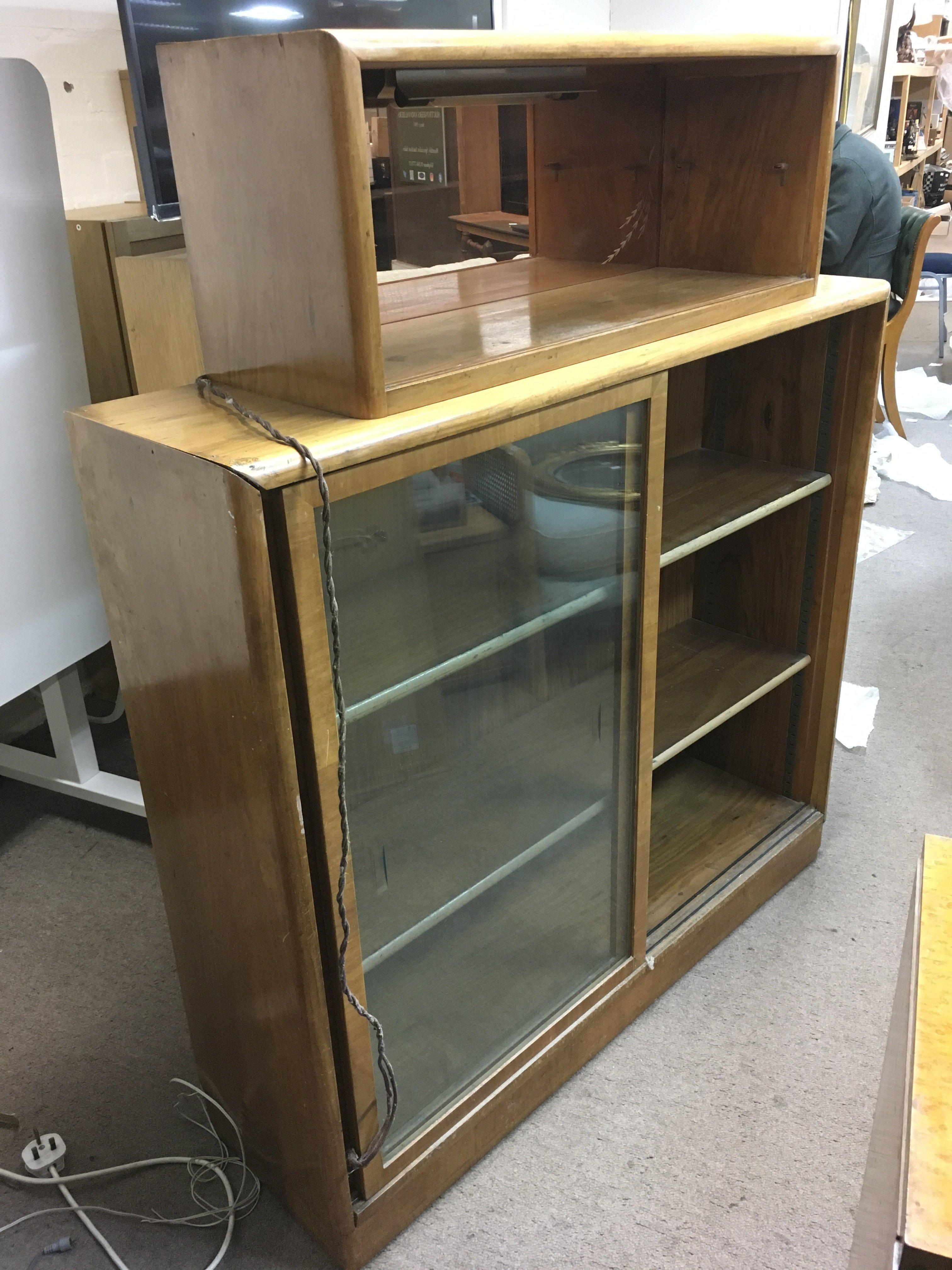 An Art Deco cabinet with peach glass mirrored back top shelf, aporox 110cm x 30cm x 130cm. Shipping category D.
