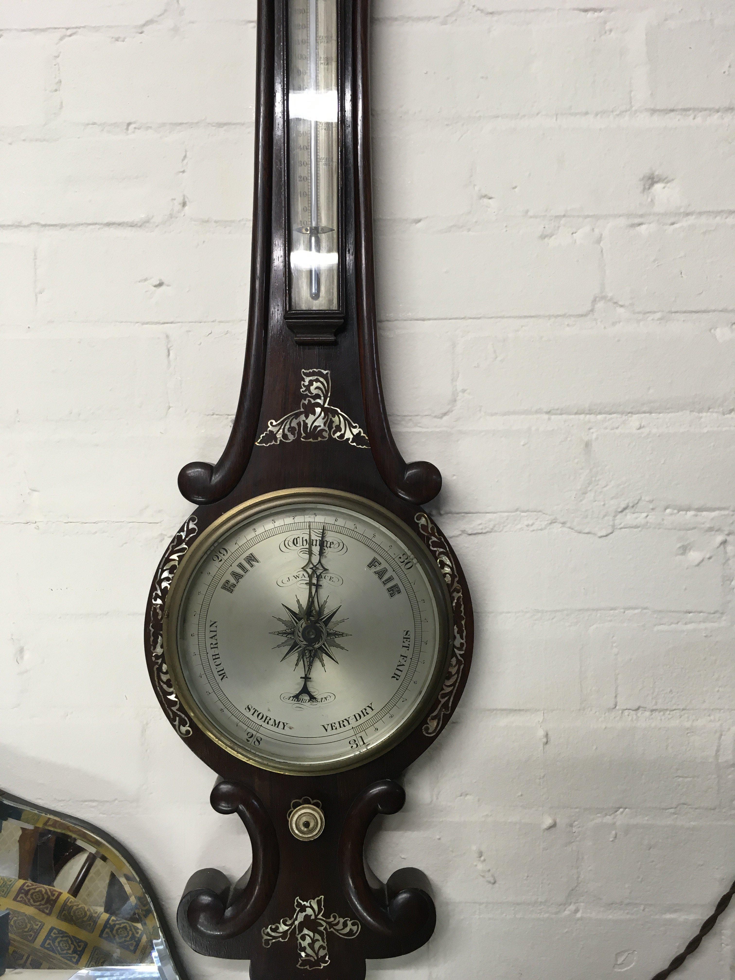 A rose wood barometer inlaid with mother of Pearl .
