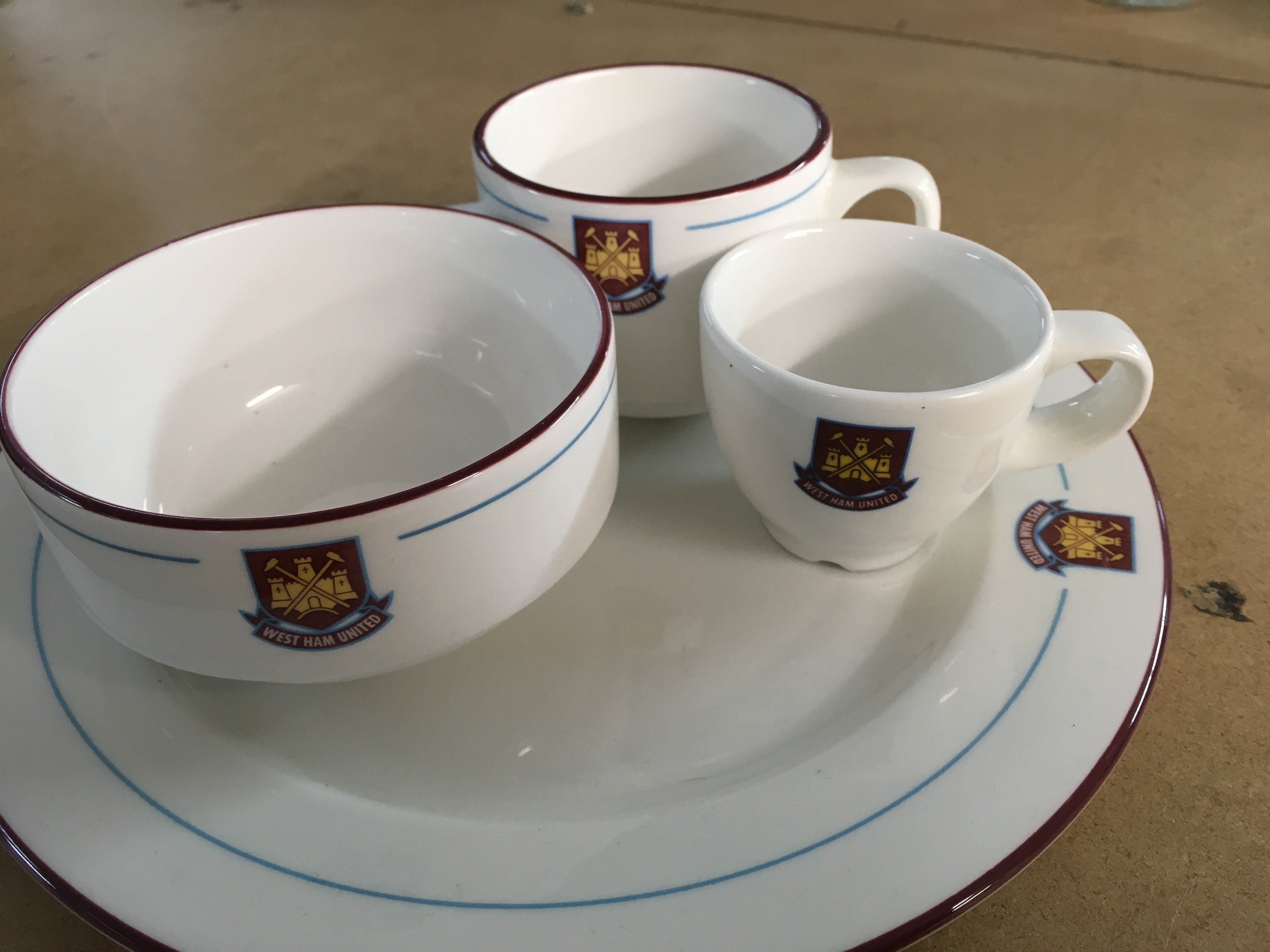 A Collection of westham ceramics comprising dinner plate tea cup coffees cup and sugar bowl .