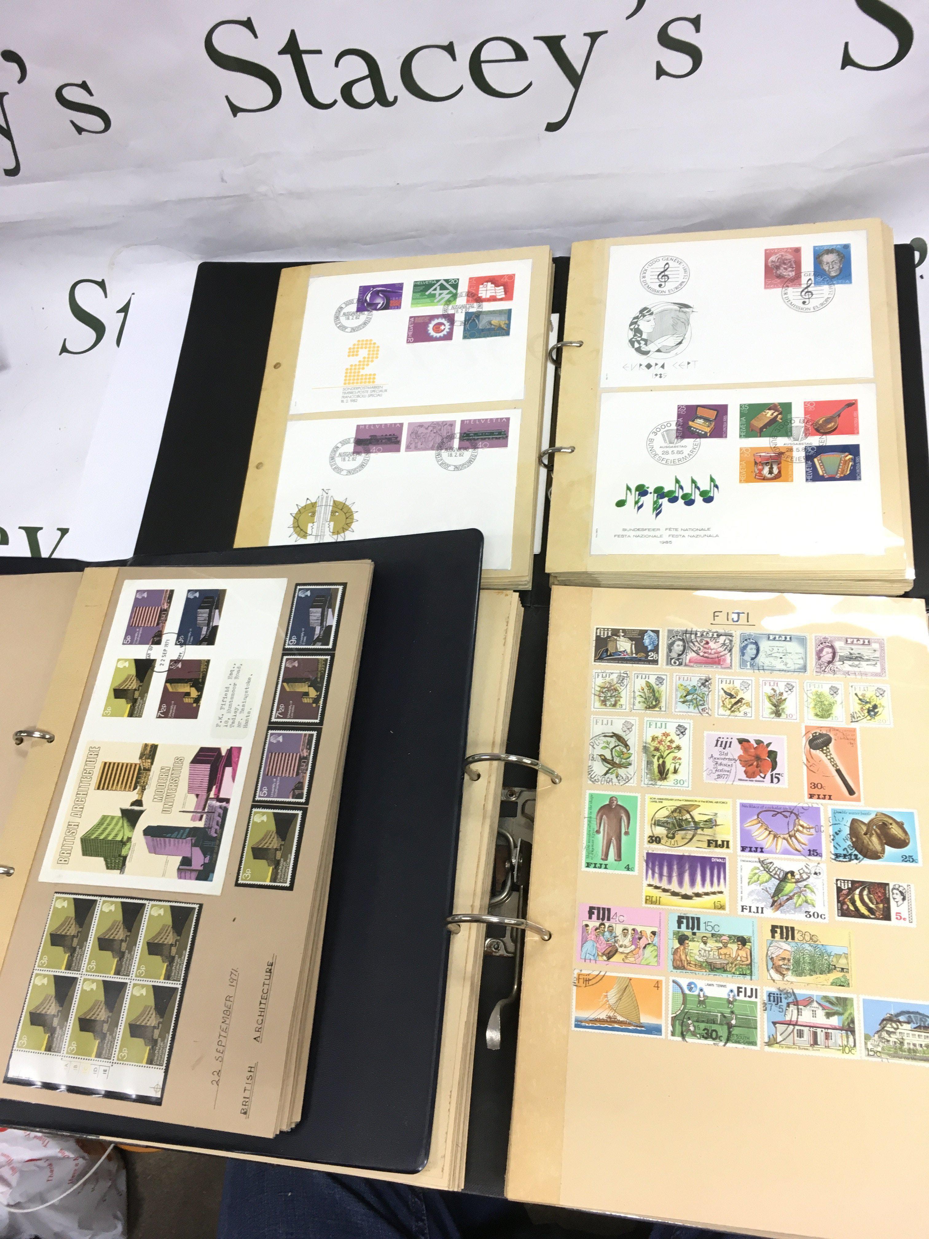 Thirteen albums of UK and world stamps and first day covers. Shipping category D.