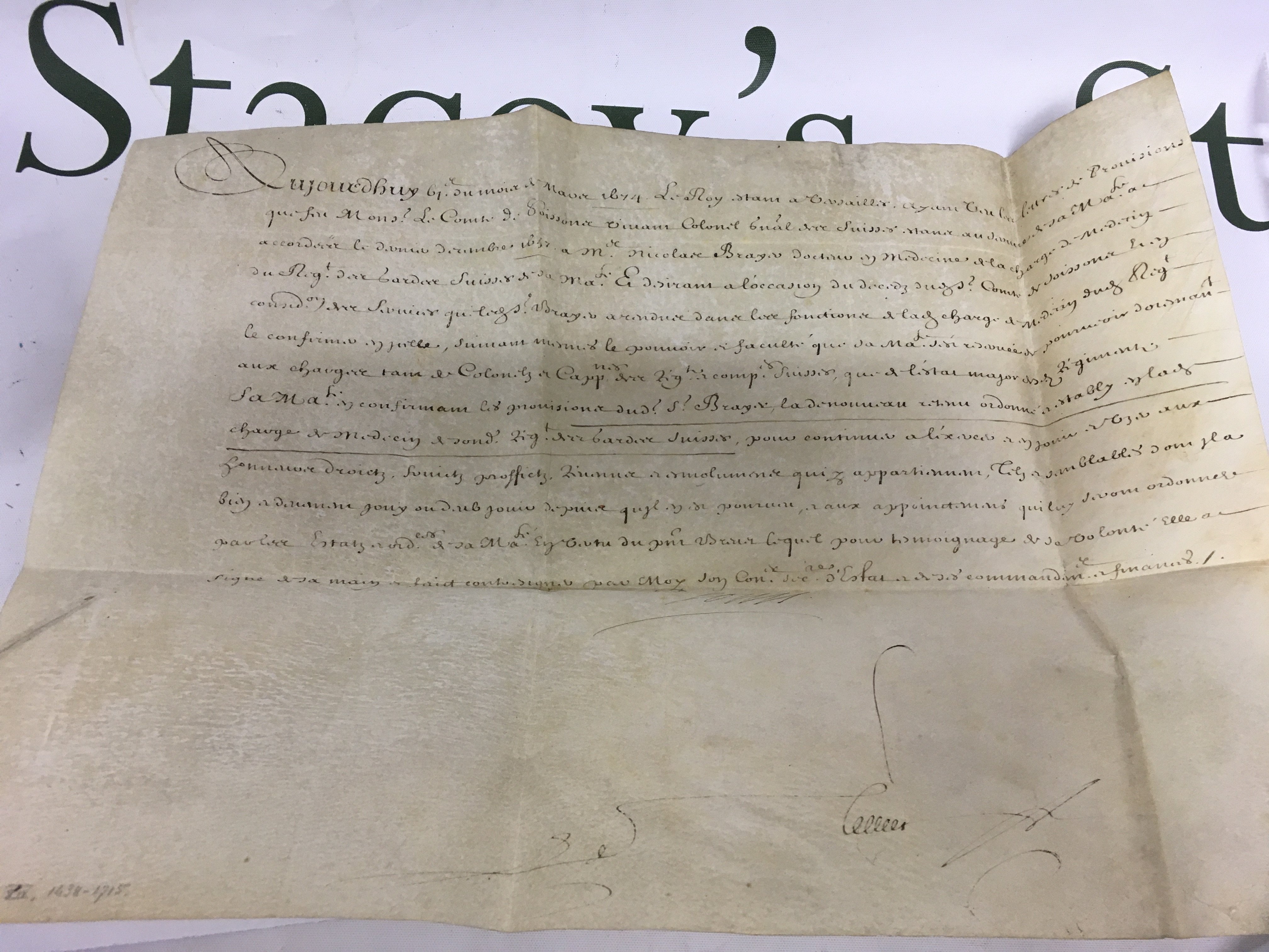 A handwritten document on vellum signed by King Louis XIV of France. Shipping category A.