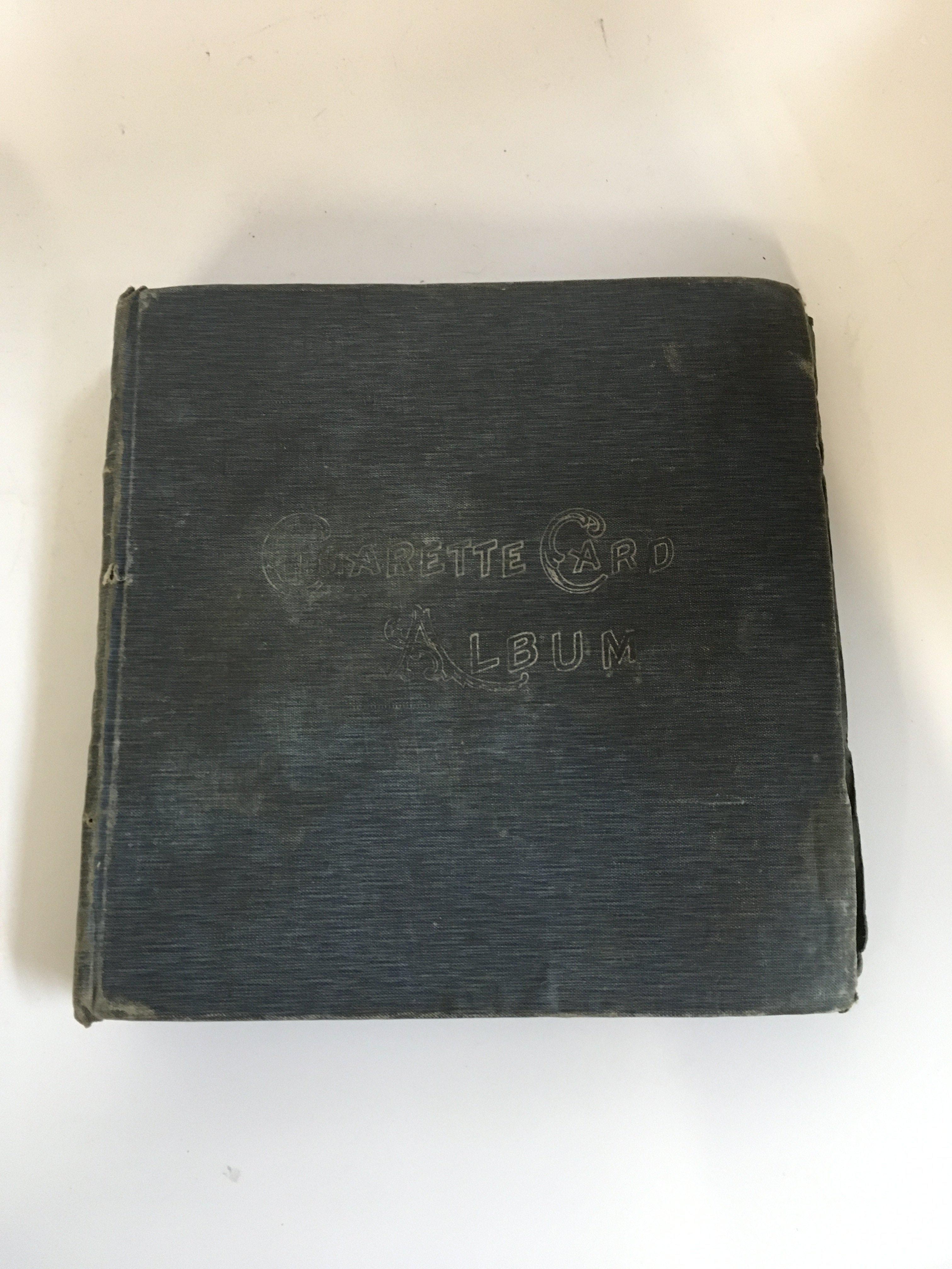 A box of loose cigarette cards and a box of 7 albums of cigarette cards