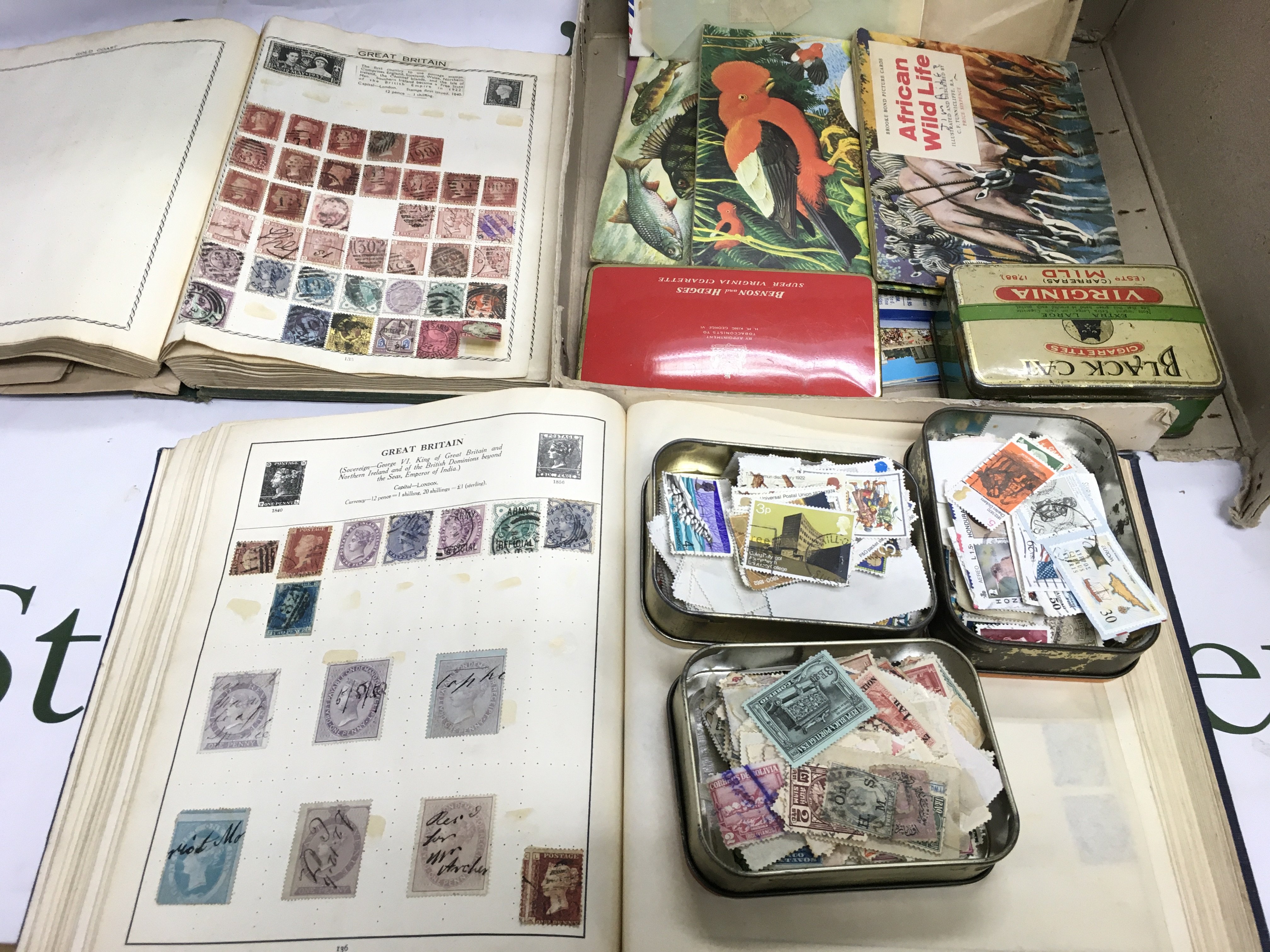 Two boxes of GB and world stamps including Penny reds plus some tea cards. Shipping category D.