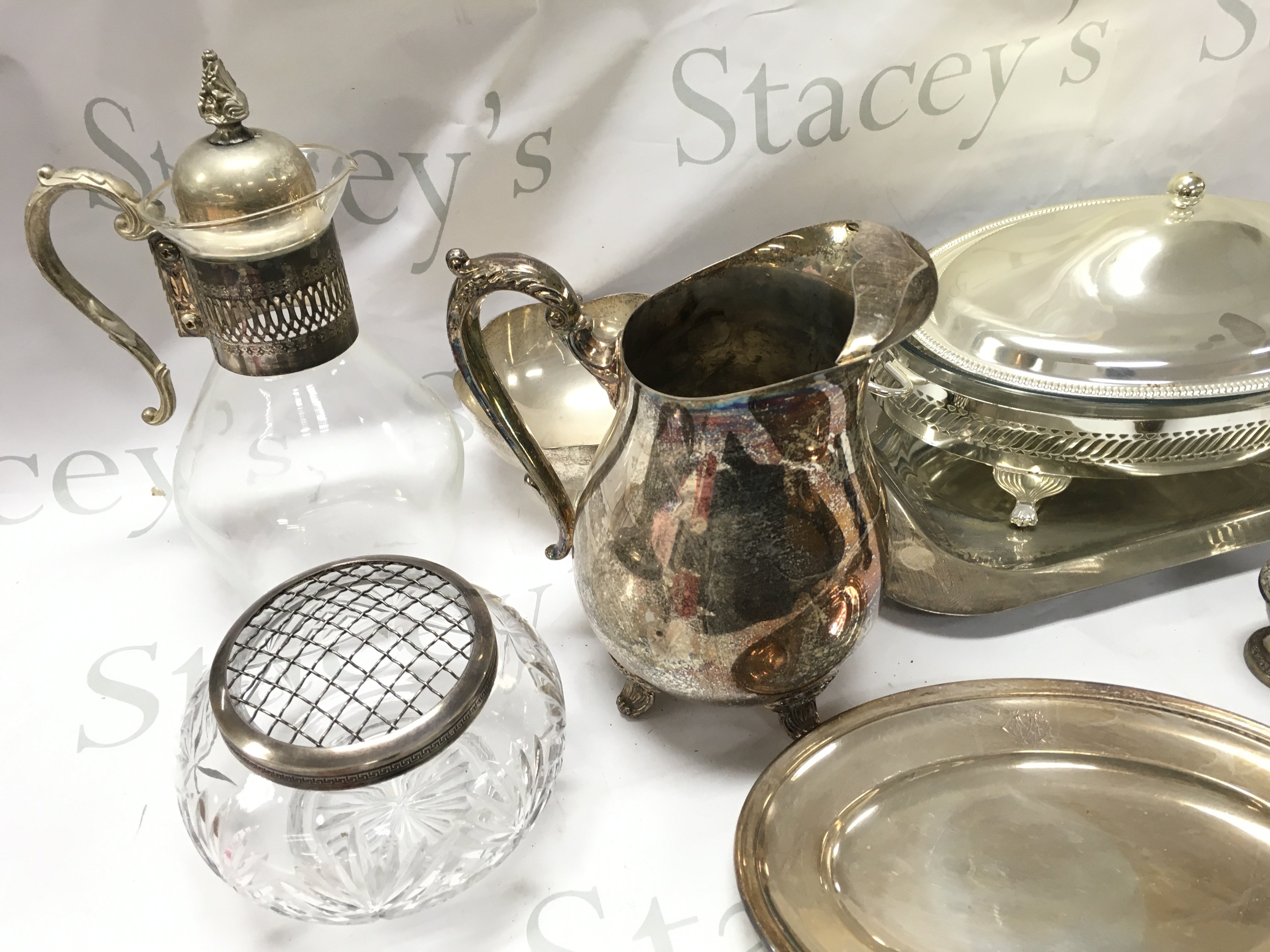 A Collection of silver plated items including Dishes, Cups, Cutlery , Galleon jug, unusual coloured glass handled cheese knives , a silver hallmarked handled pie server,two silver copies of a traditional religious icons George slaying the dragon and virgin Mary. This lot cannot be posted- NO RESERVE