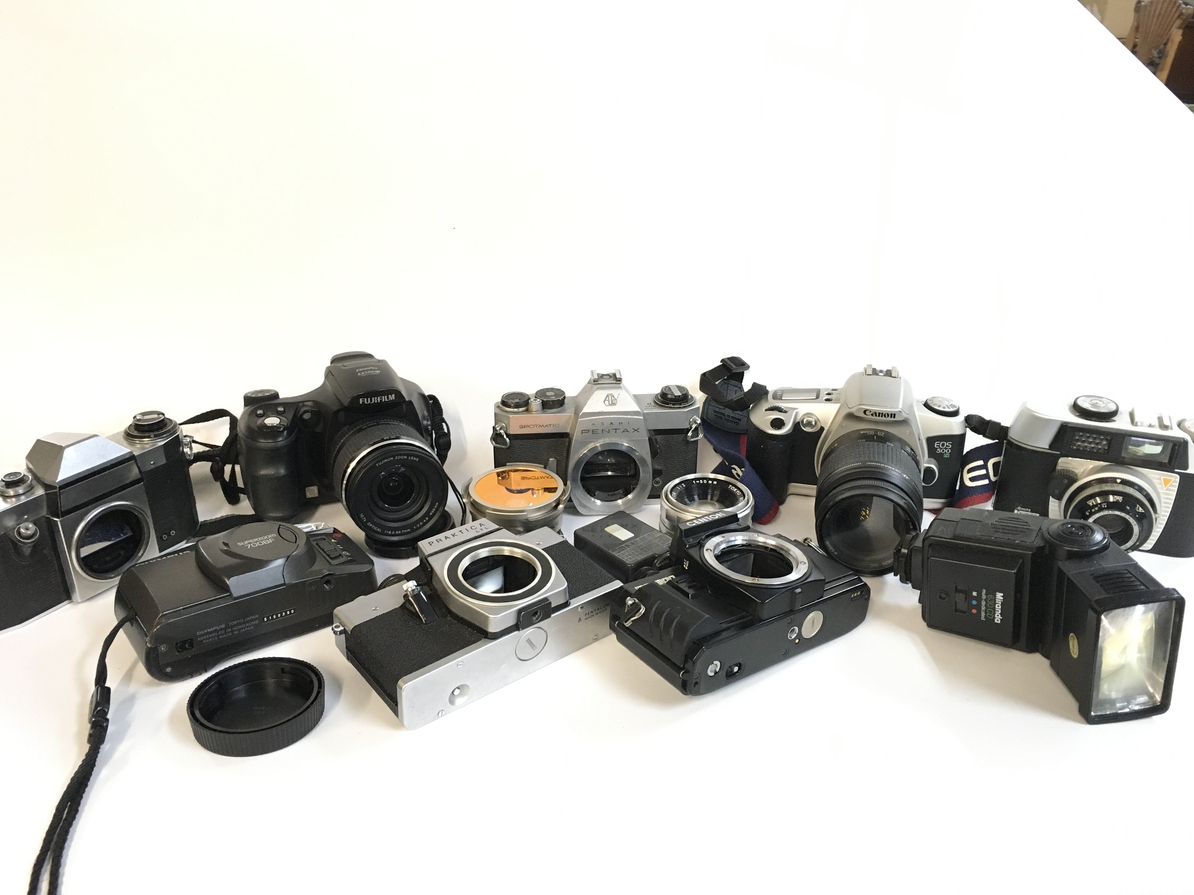 A Collection of vintage cameras including Asahi Pentax, Fujifilm, Canon EOS 500N, Olympus etc