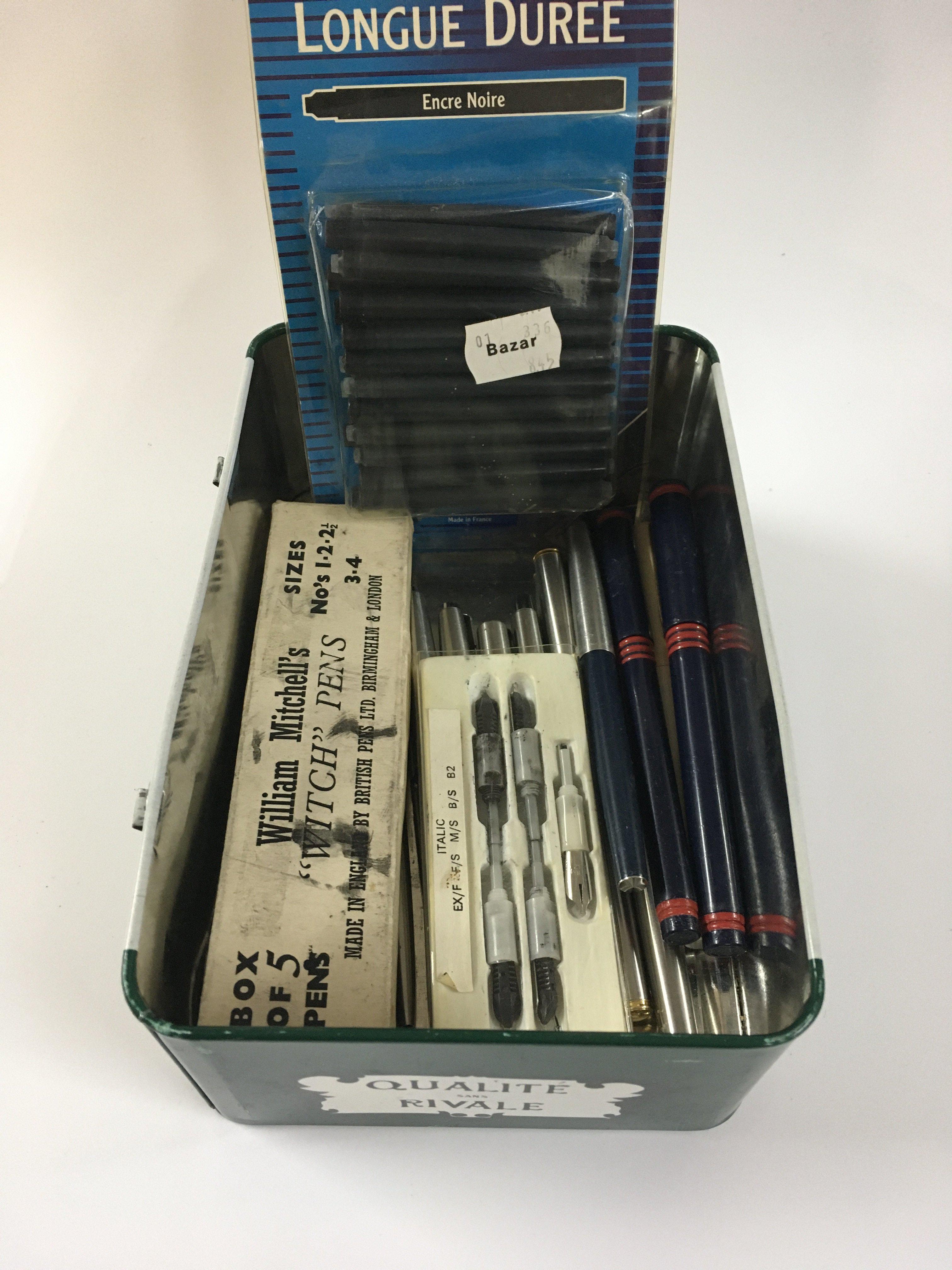 A tin box containing pens some Parker pen examples and ink refills.