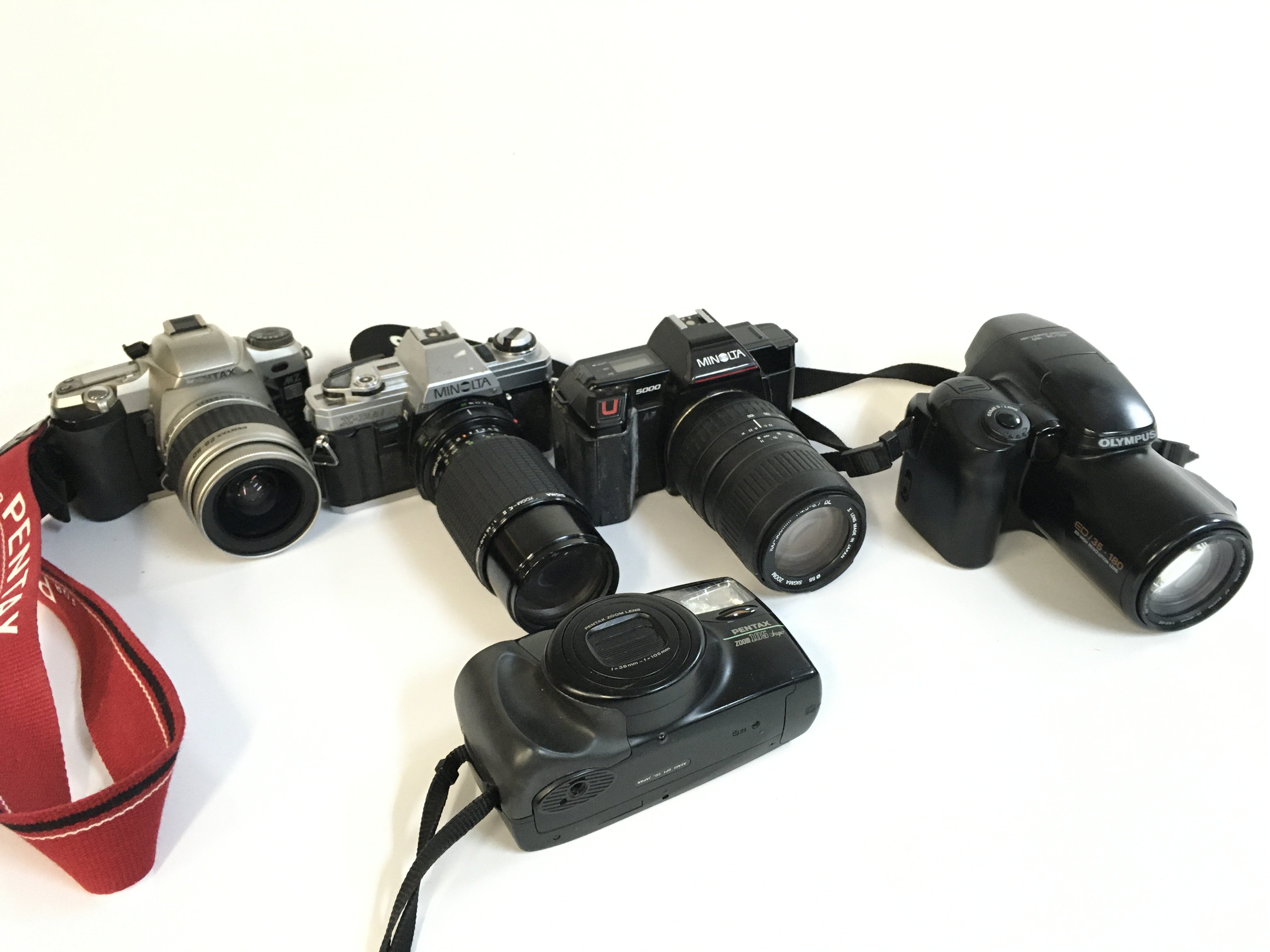 Five vintage cameras including Olympus, Minolta, Pentax etc . Postage category C