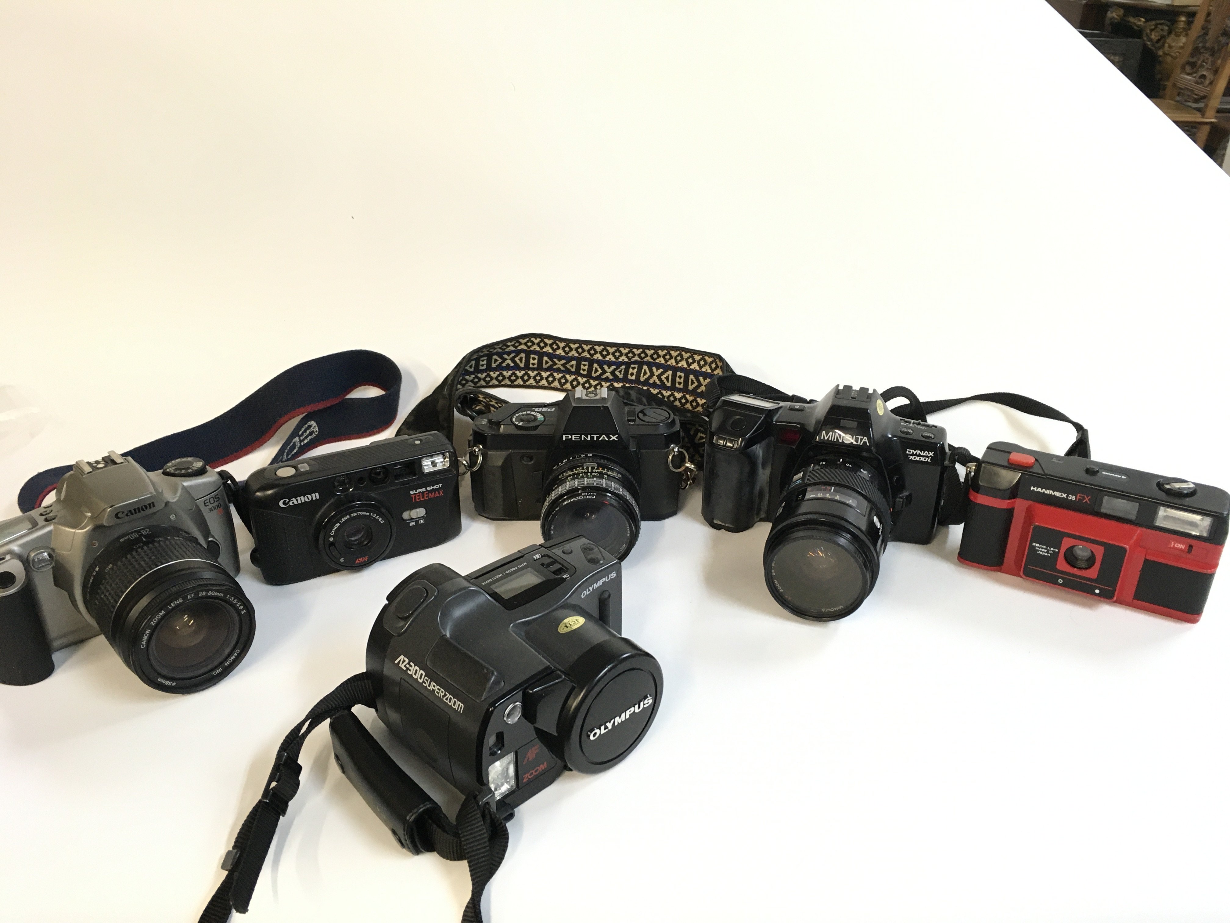 A Collection of vintage cameras including Hanimex, Minolta, Pentax, Canon, Olympus . Postage category C