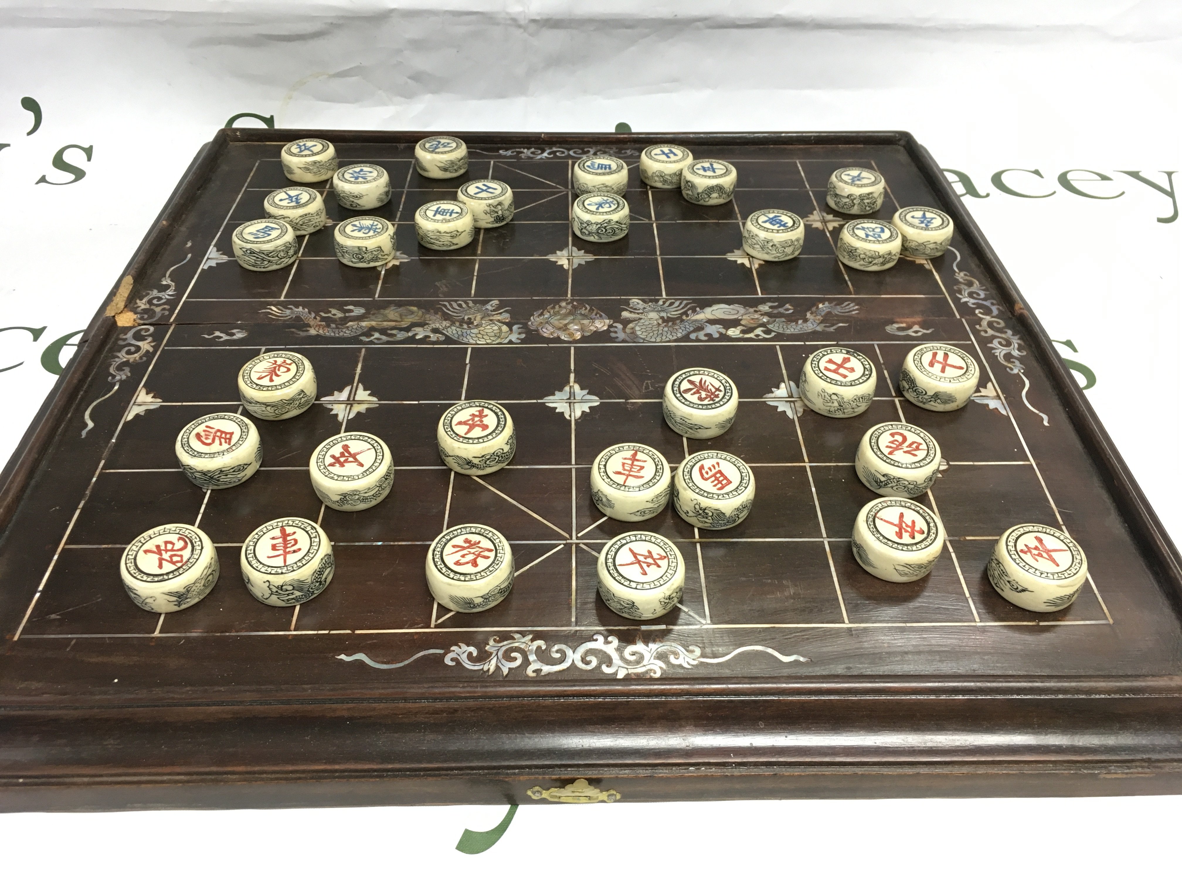 A Chinese board game inset with mother of pearl decoration. Shipping category C.