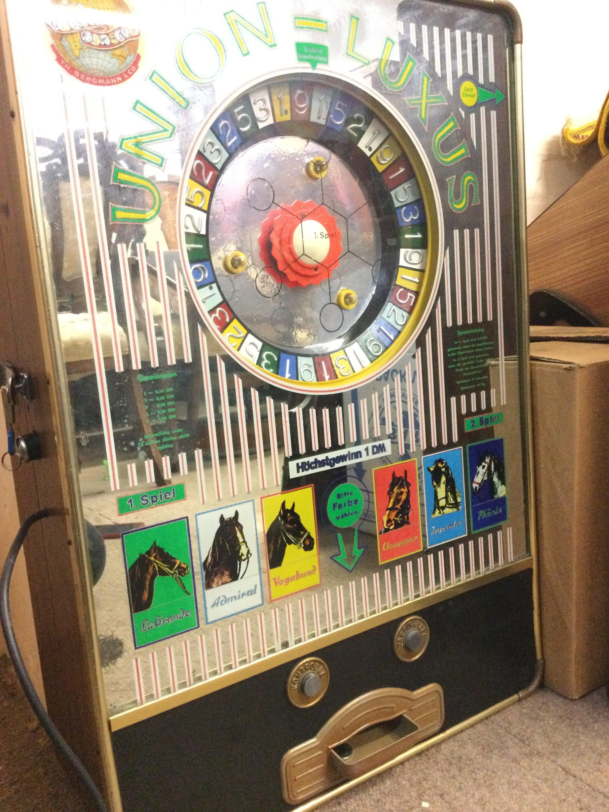 A German Wall Mounted Union-Luxus Gaming Machine by Bergmann And Co. Approx Height 73Cm.