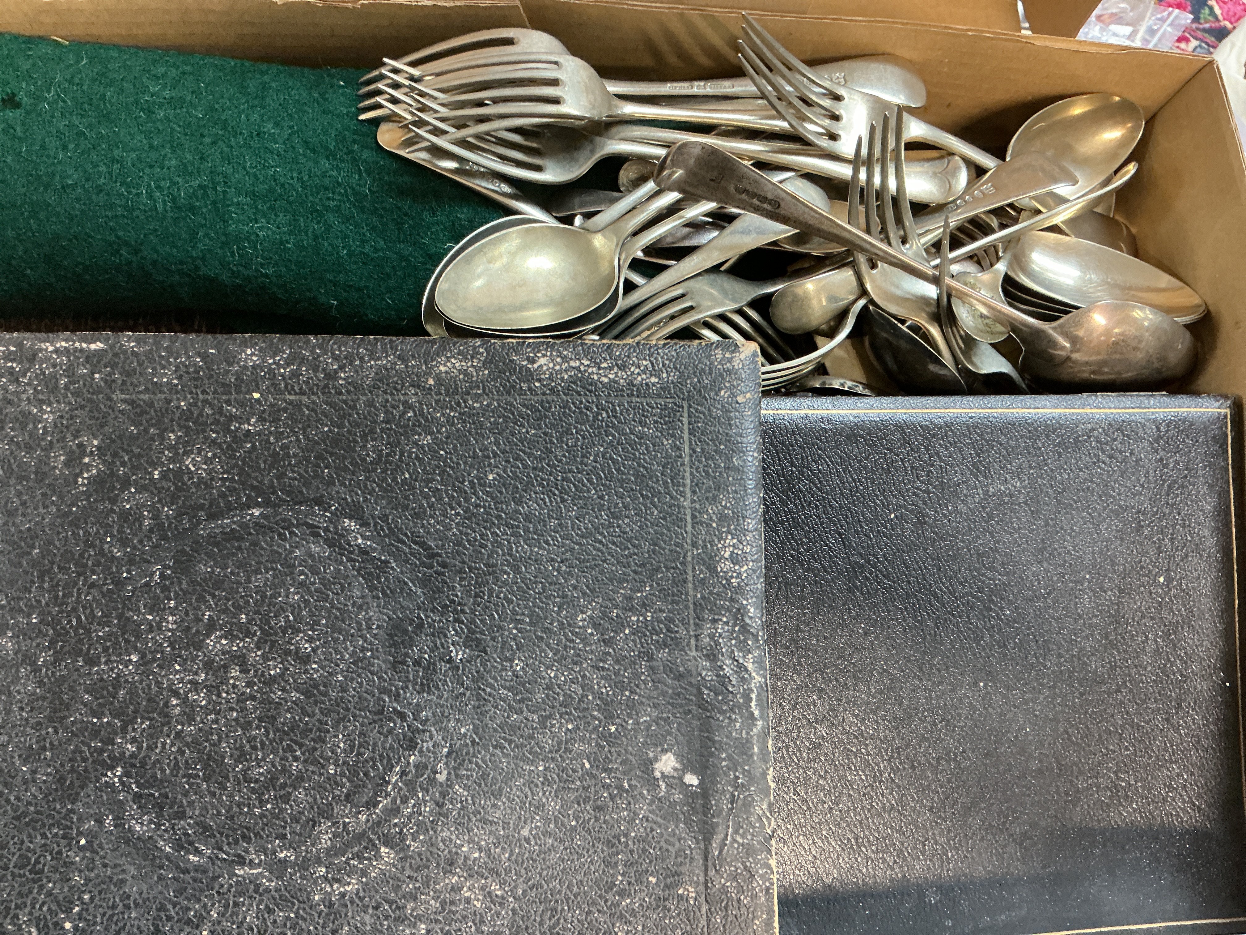 A box of various silver plate cutlery sets.