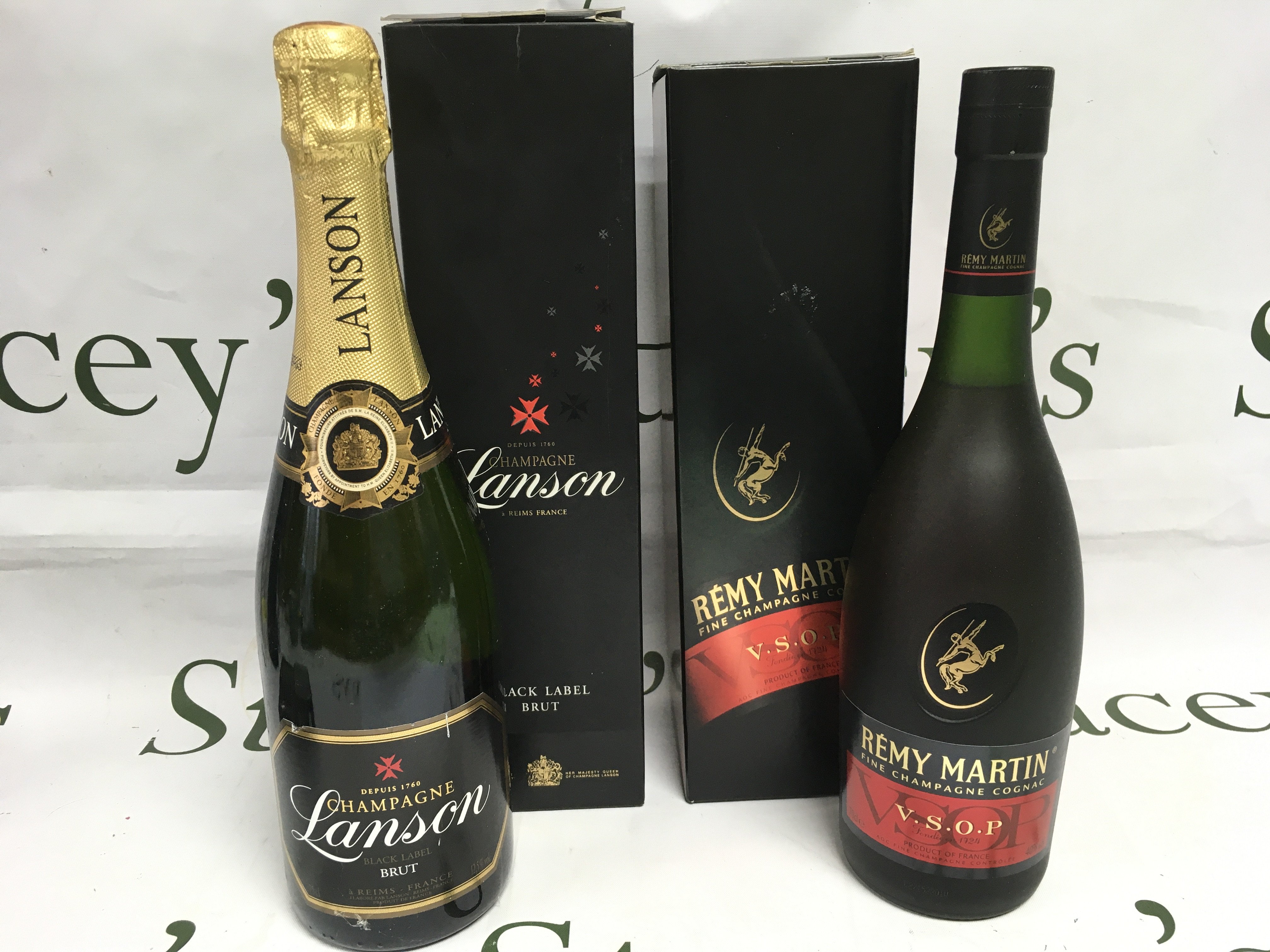 Two bottles of champagne comprising a black label Landon brut and a Remy Martin champagne cognac. Shipping category D.