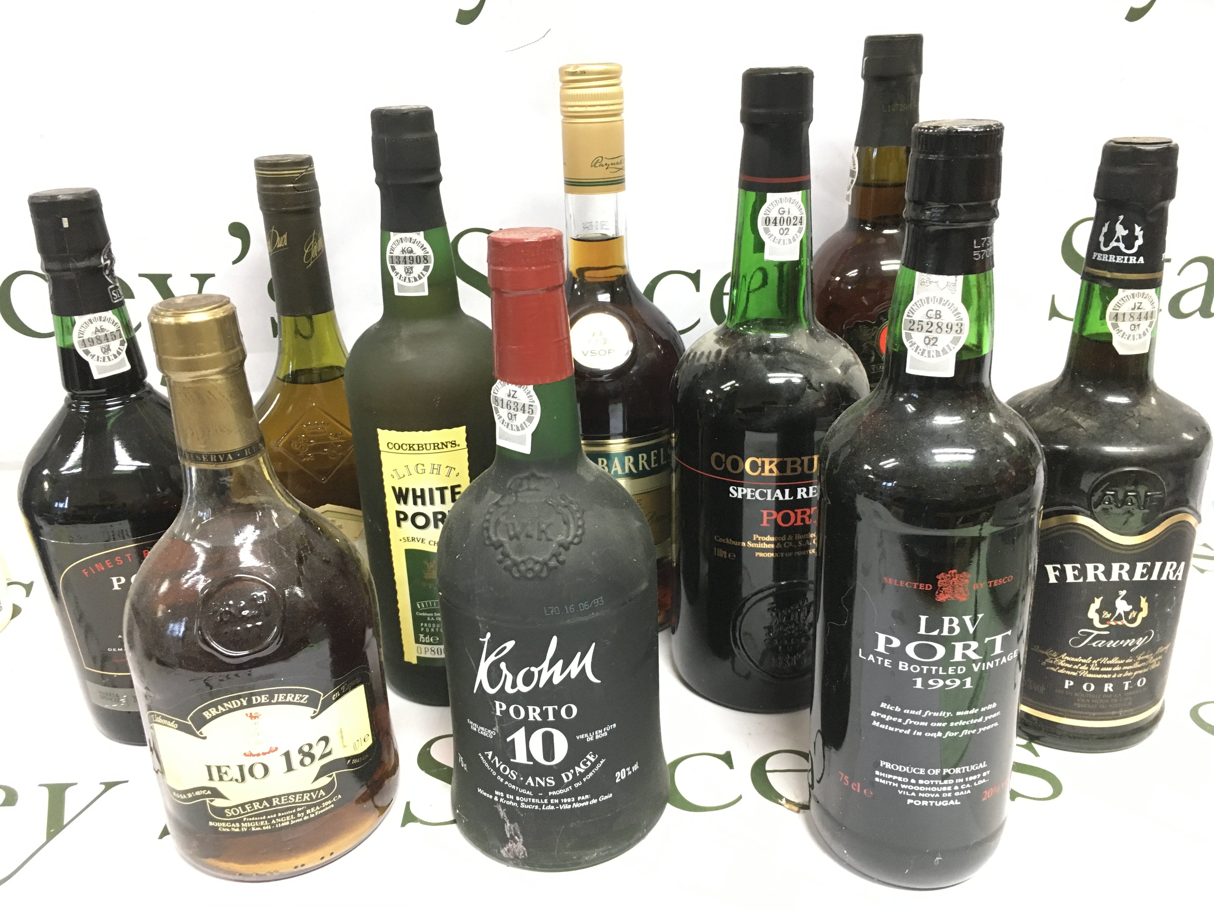 Ten bottles of port and brandy comprising examples by Taylor's, Cockburns, Three Barrels and others. Shipping category D.