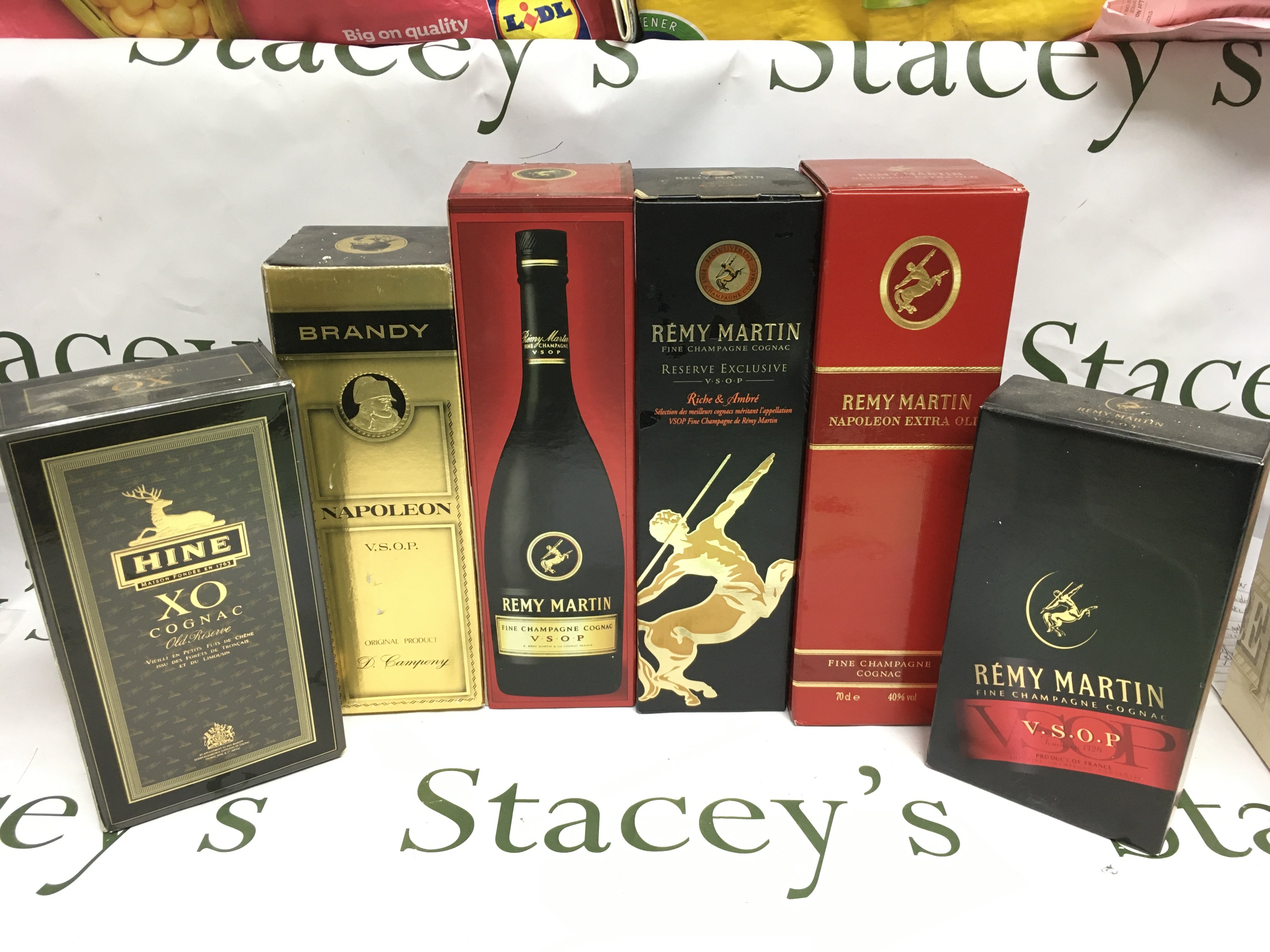 Six bottles of brandy and cognac including Remy Martin, Napoleon and Hine examples. Shipping category D.
