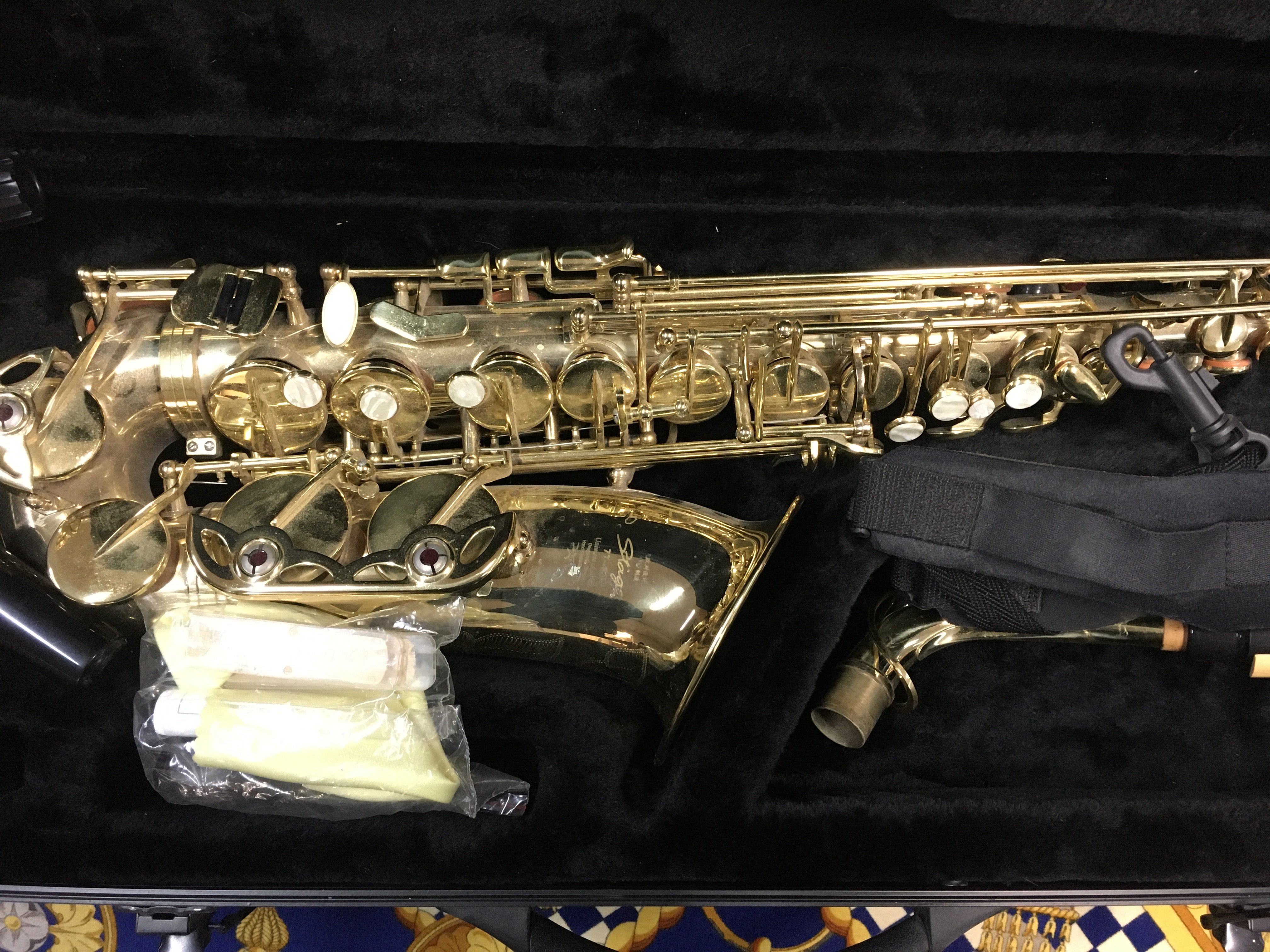 A stagg saxophone fitted in original case .