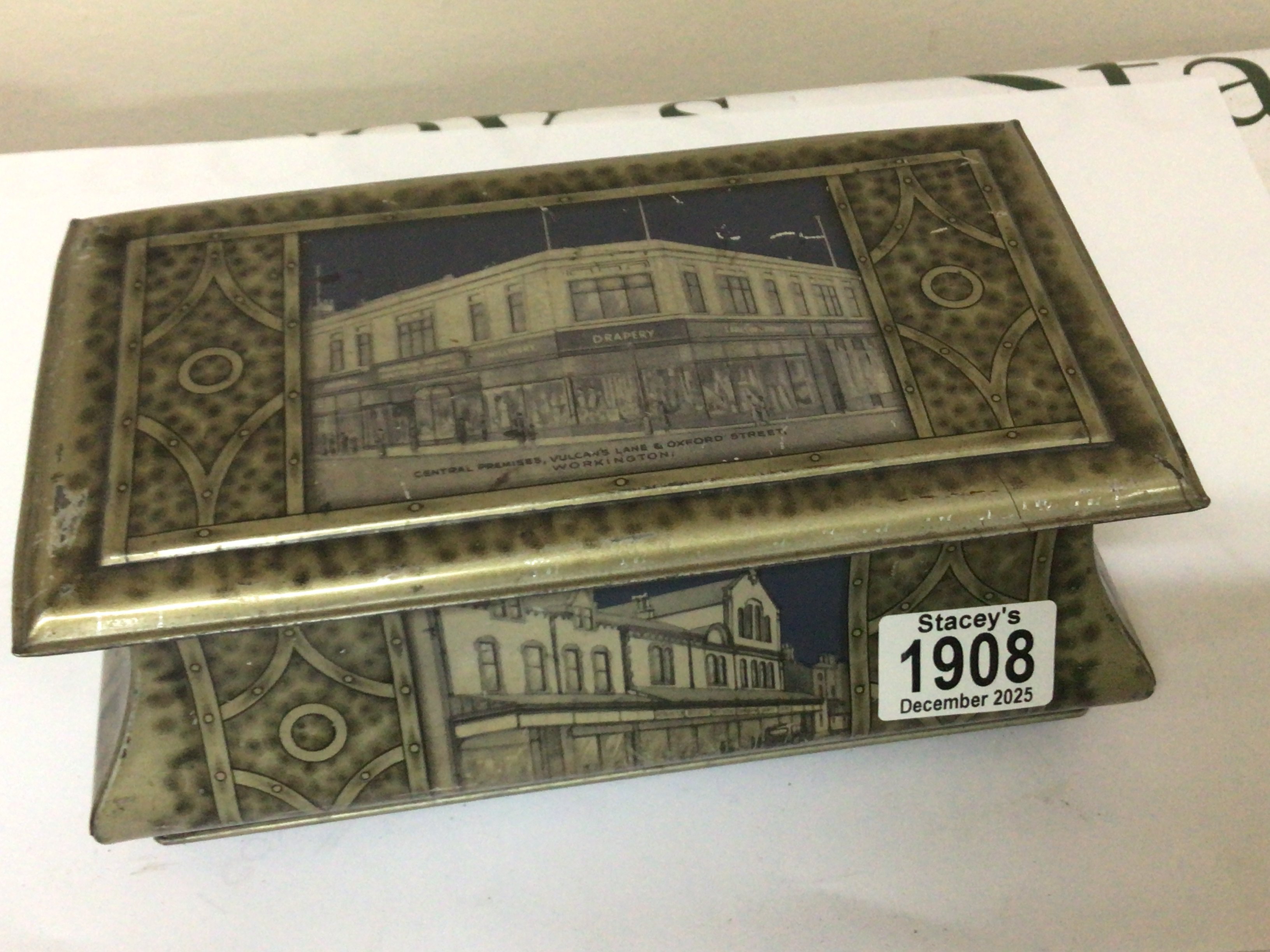 A Vintage biscuit tin depicting The Co-operative Society 1934 Vulcan Lane and Oxford Street Workington.