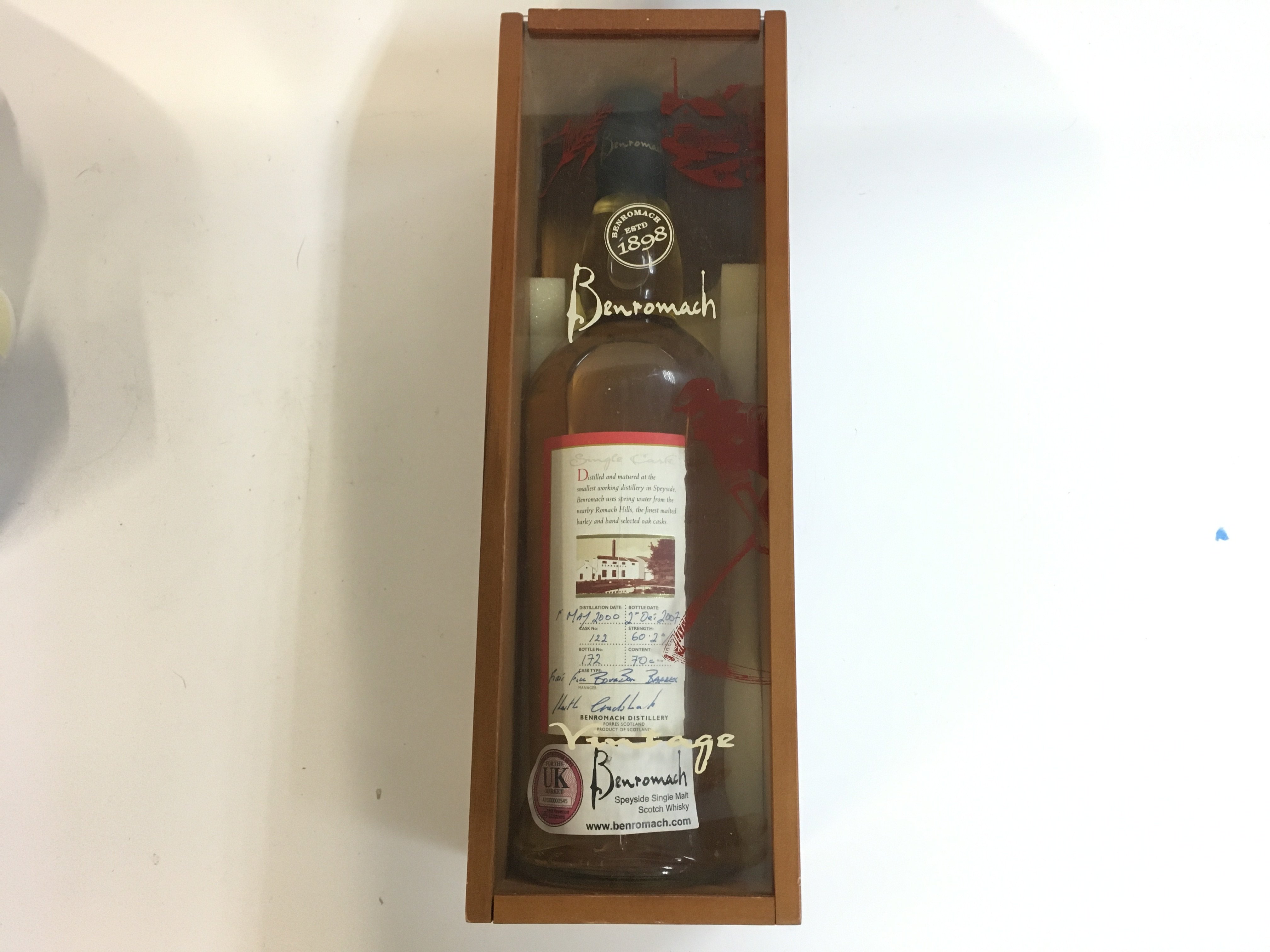 A limited edition single malt Benromach whiskey with a hand written label, bottled on 2/12/2007 distilled 1/5/2000 bottle number 172 7 years old when bottled, in a fitted case