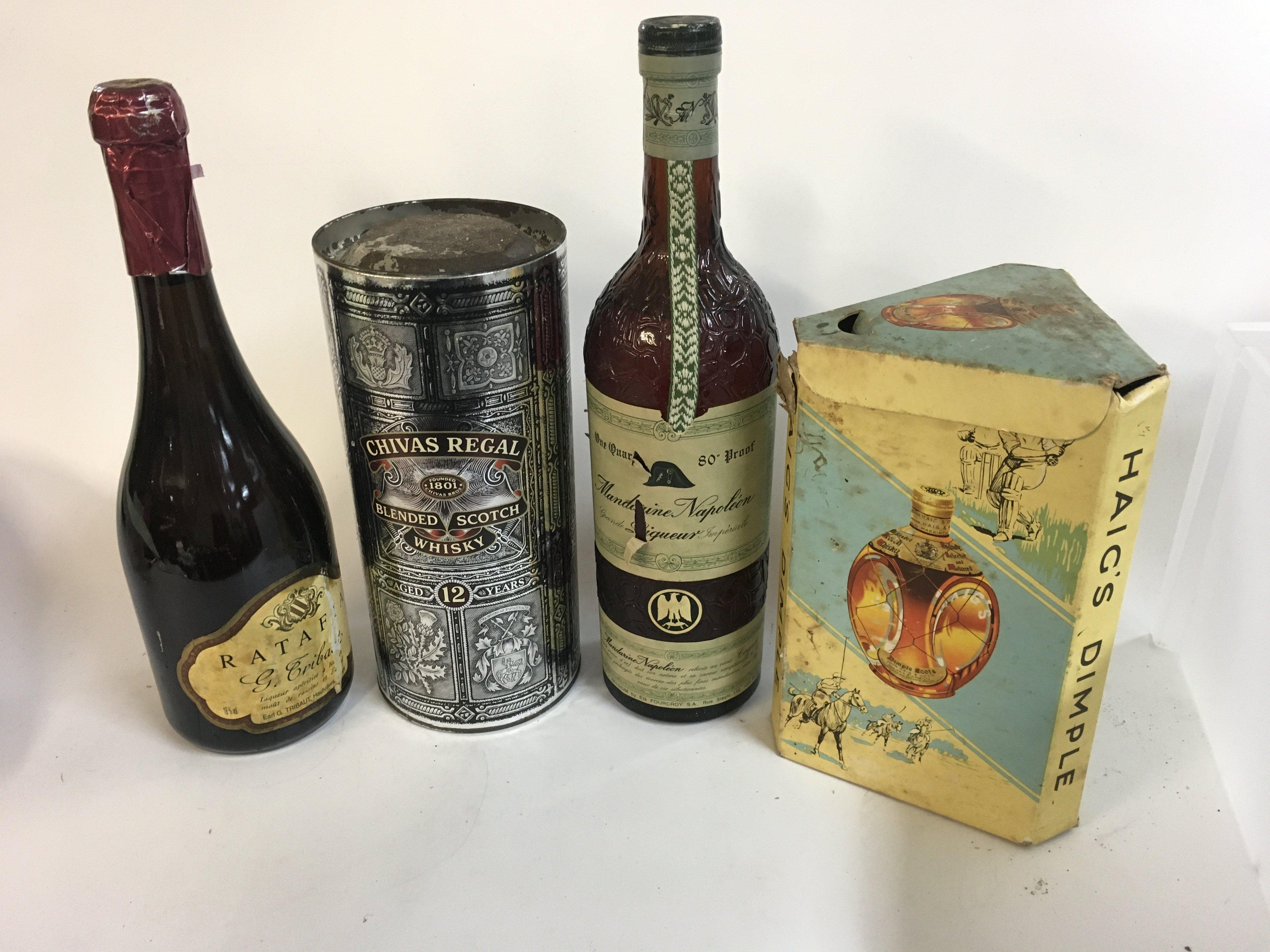 4x bottles of various alcohols consisting of a Chivas Regal whiskey, Haig&#2013266057۪s dimple whiskey, Mandarine Napoleon and Ratafia G.Tribaut