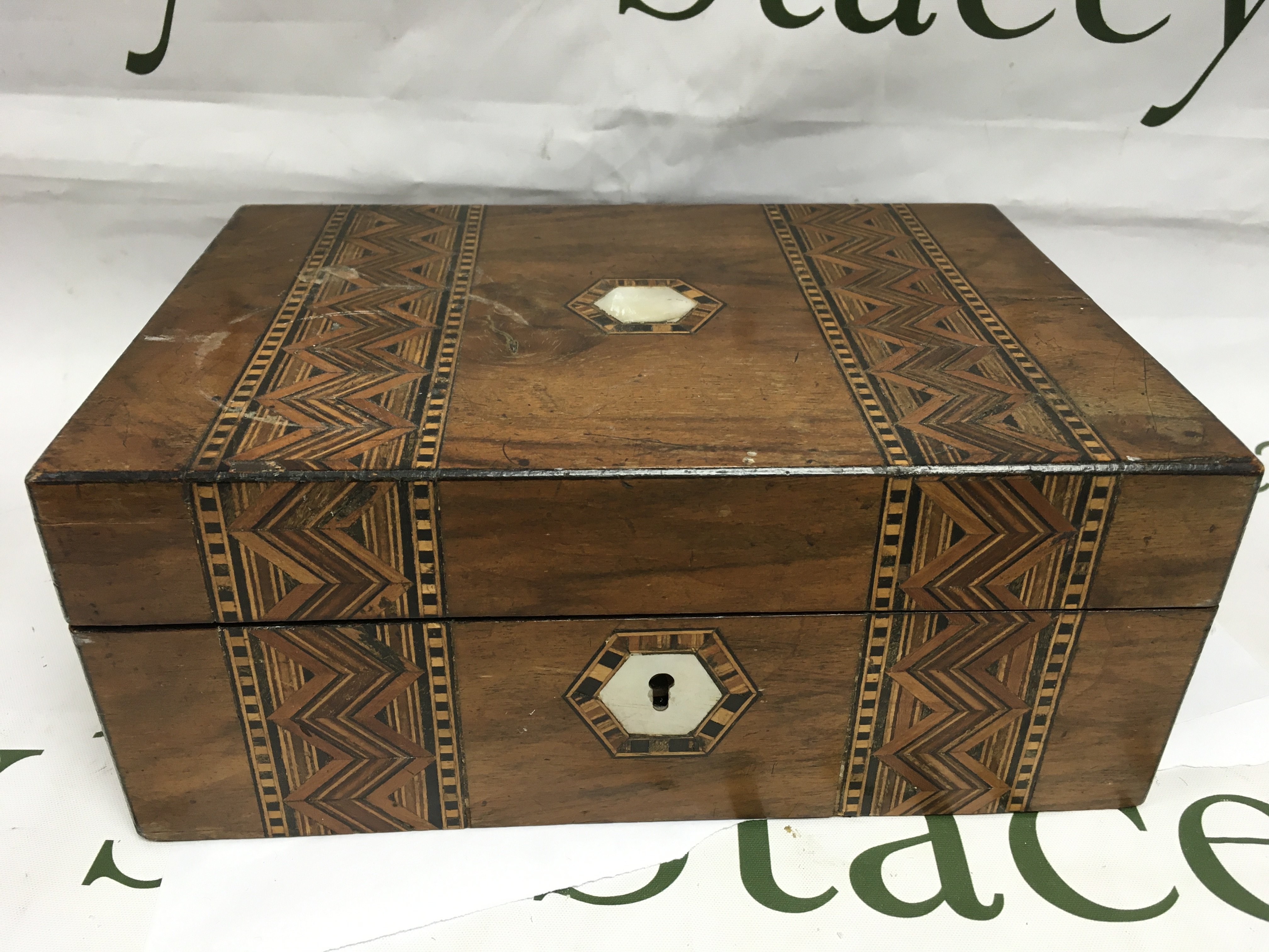 A walnut box containing watches.