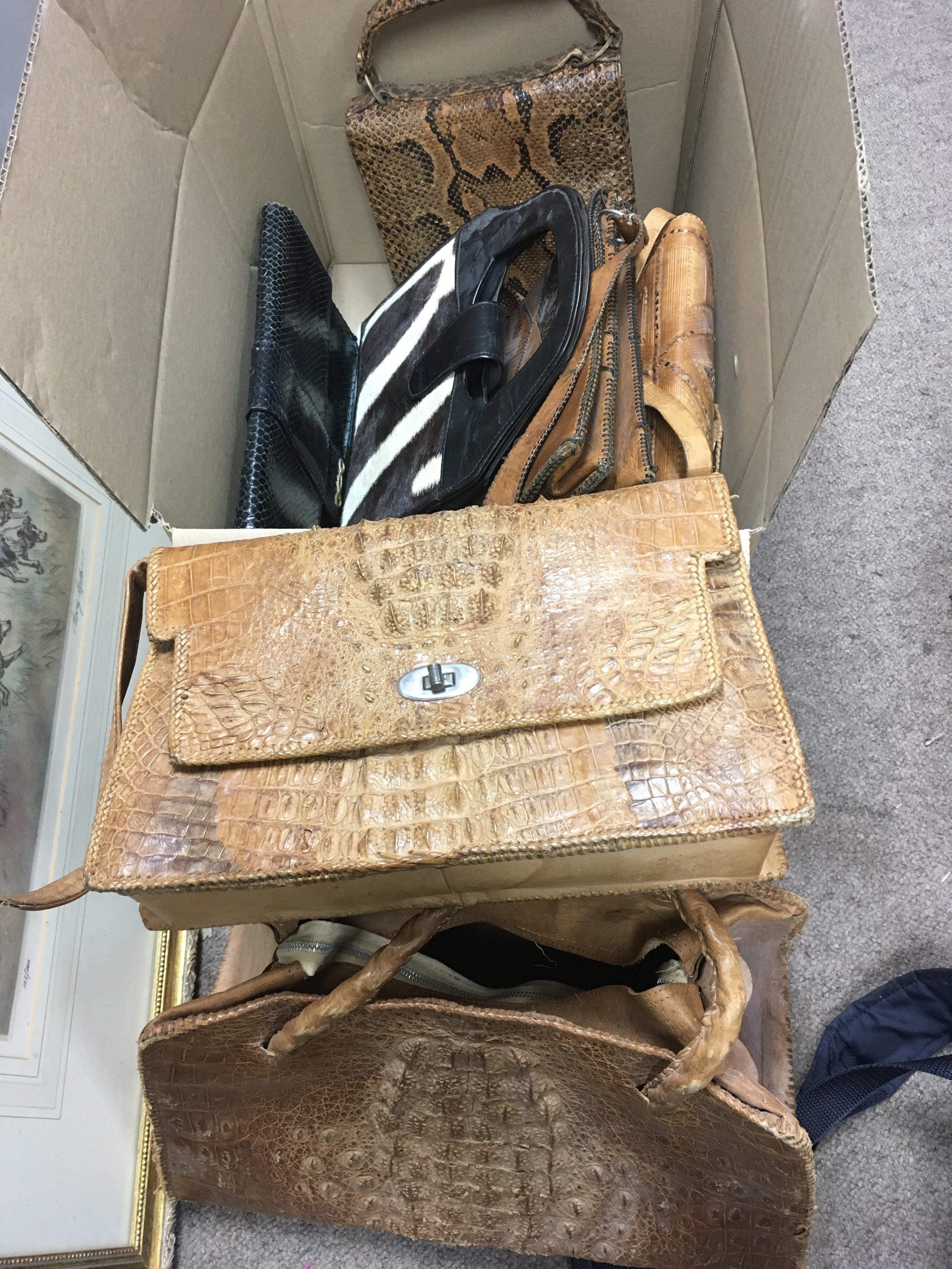 A collection of ladies handbags comprising snakeskin and crocodile skin examples plus a small sewing box and a framed religious picture. Shipping category D.