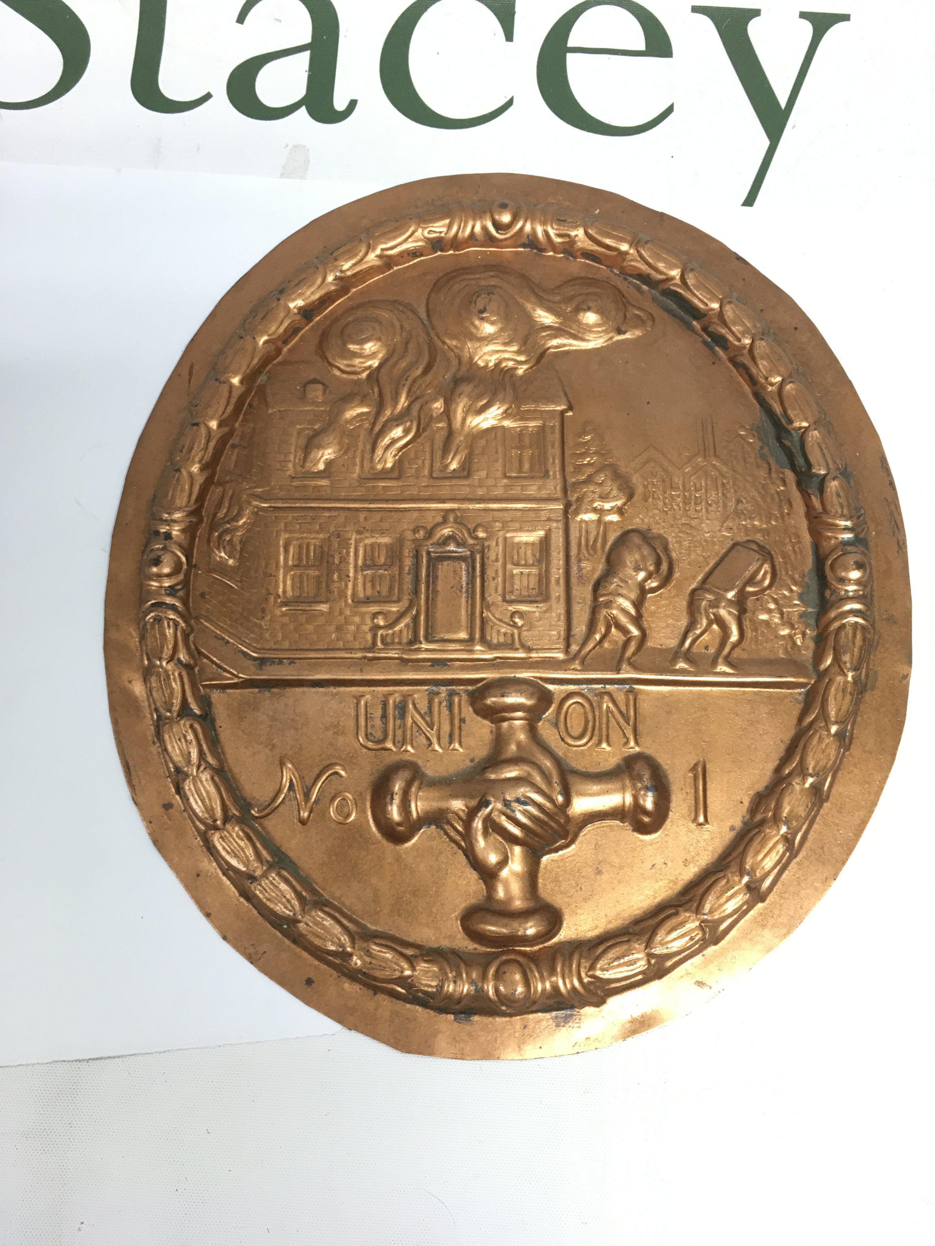 A copper fire plaque, approx width 18.5cm. Shipping category B.