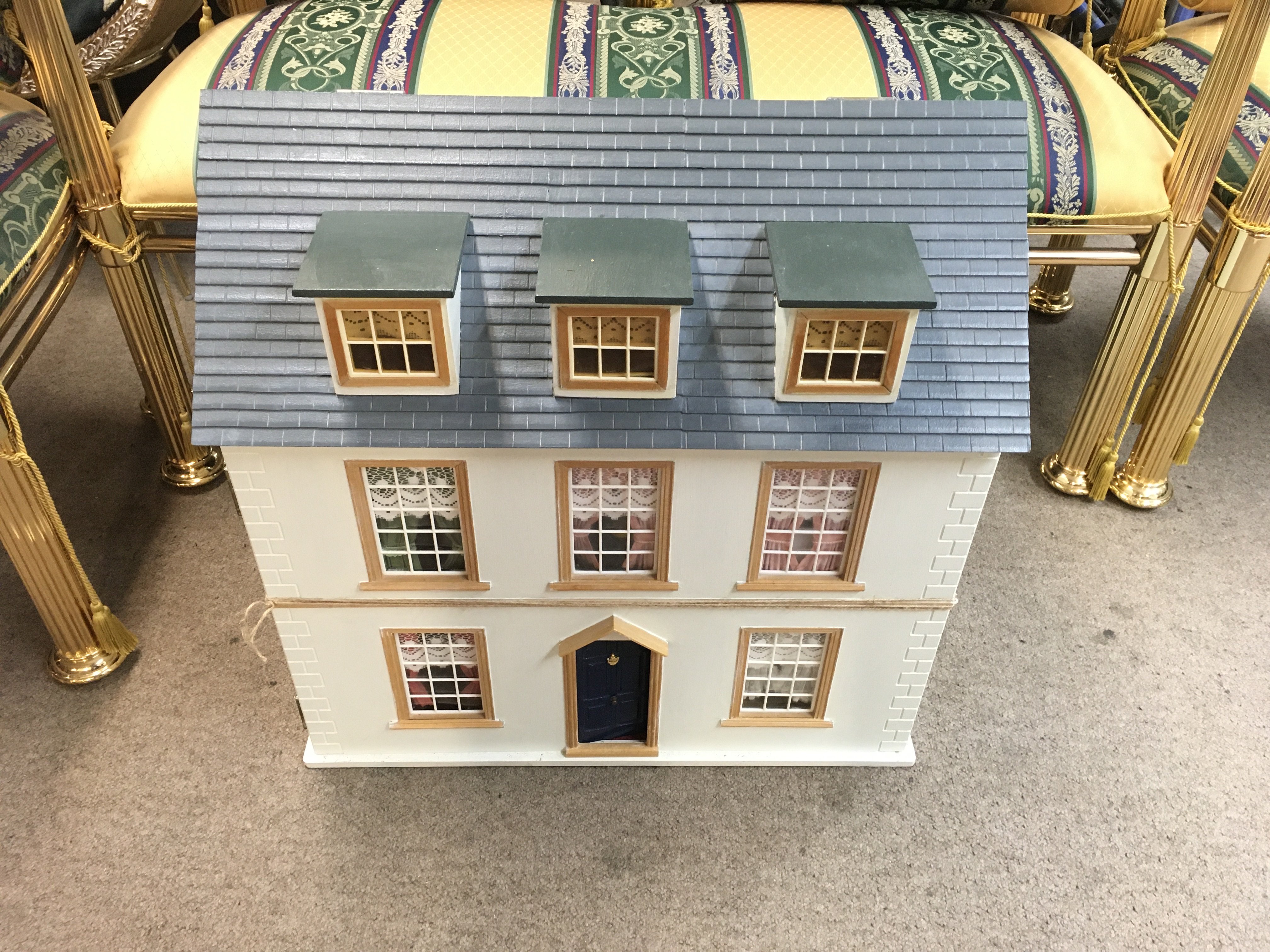 A large dolls house with lots of furniture and fittings included. 62cm wide 38cm deep 63cm tall. Postage D