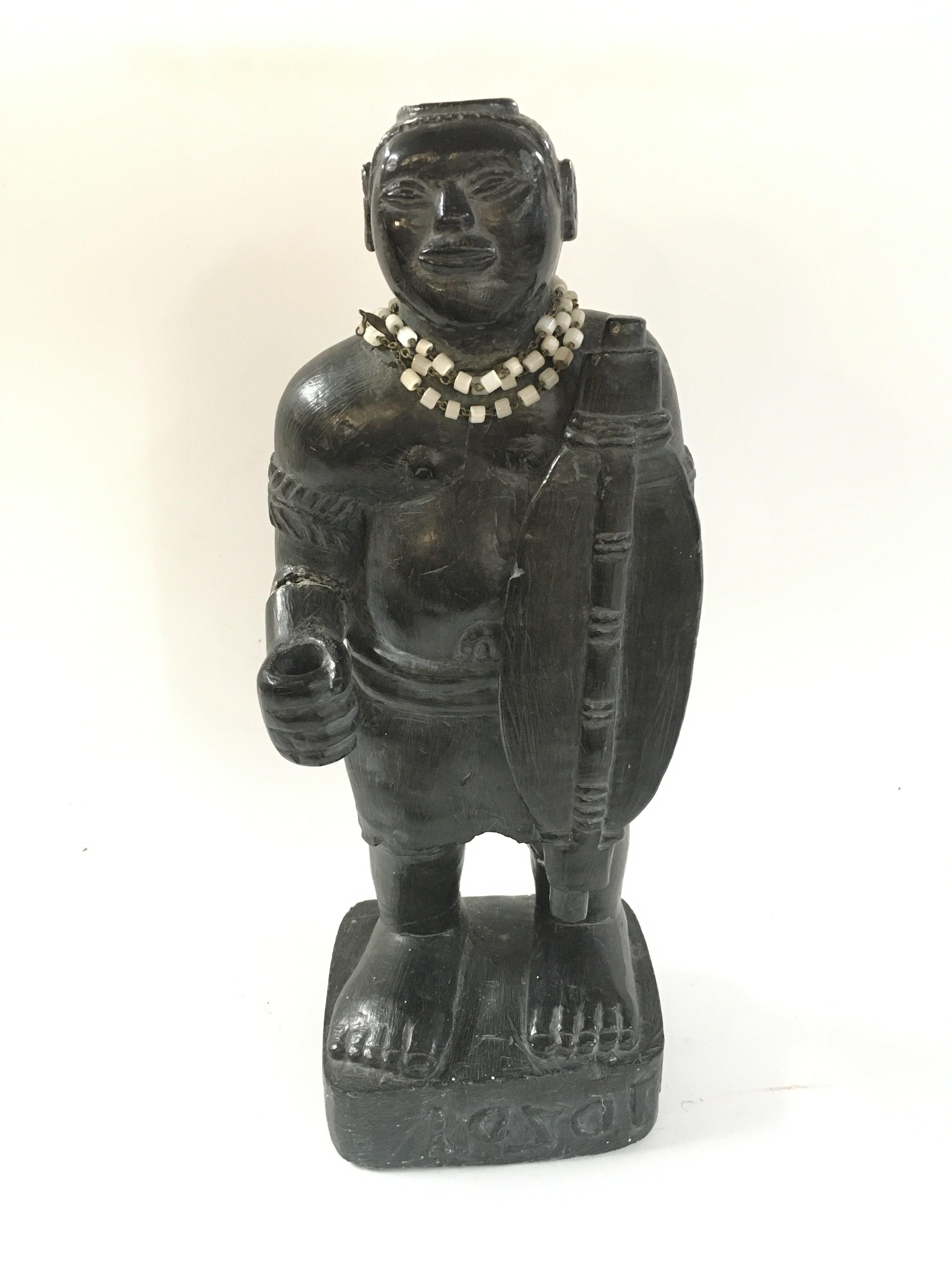 A carved stone African tribal hunter figure , 32cm tall.