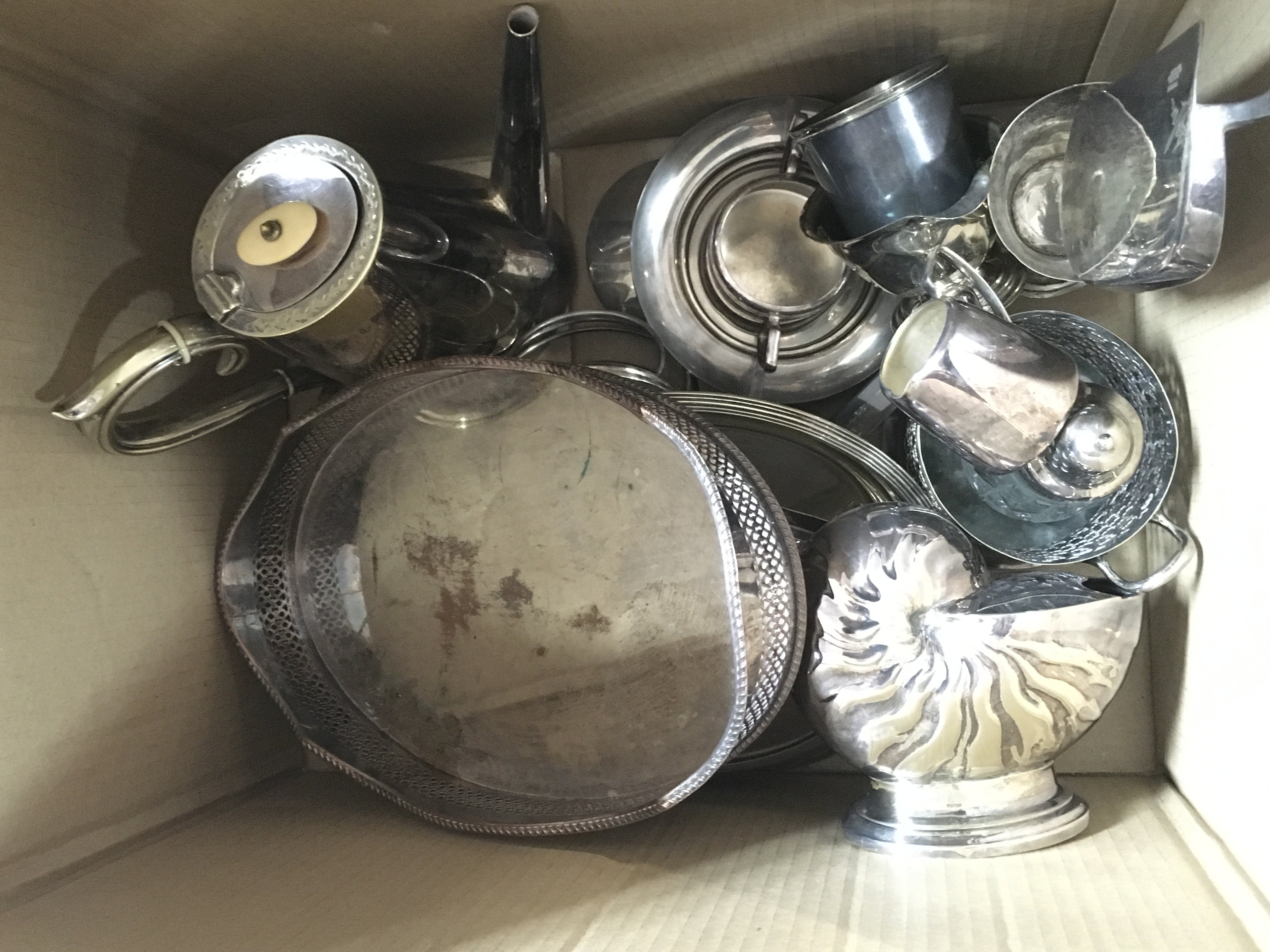 A collection of silver plate including a jugs, trays, spoon warmer etc