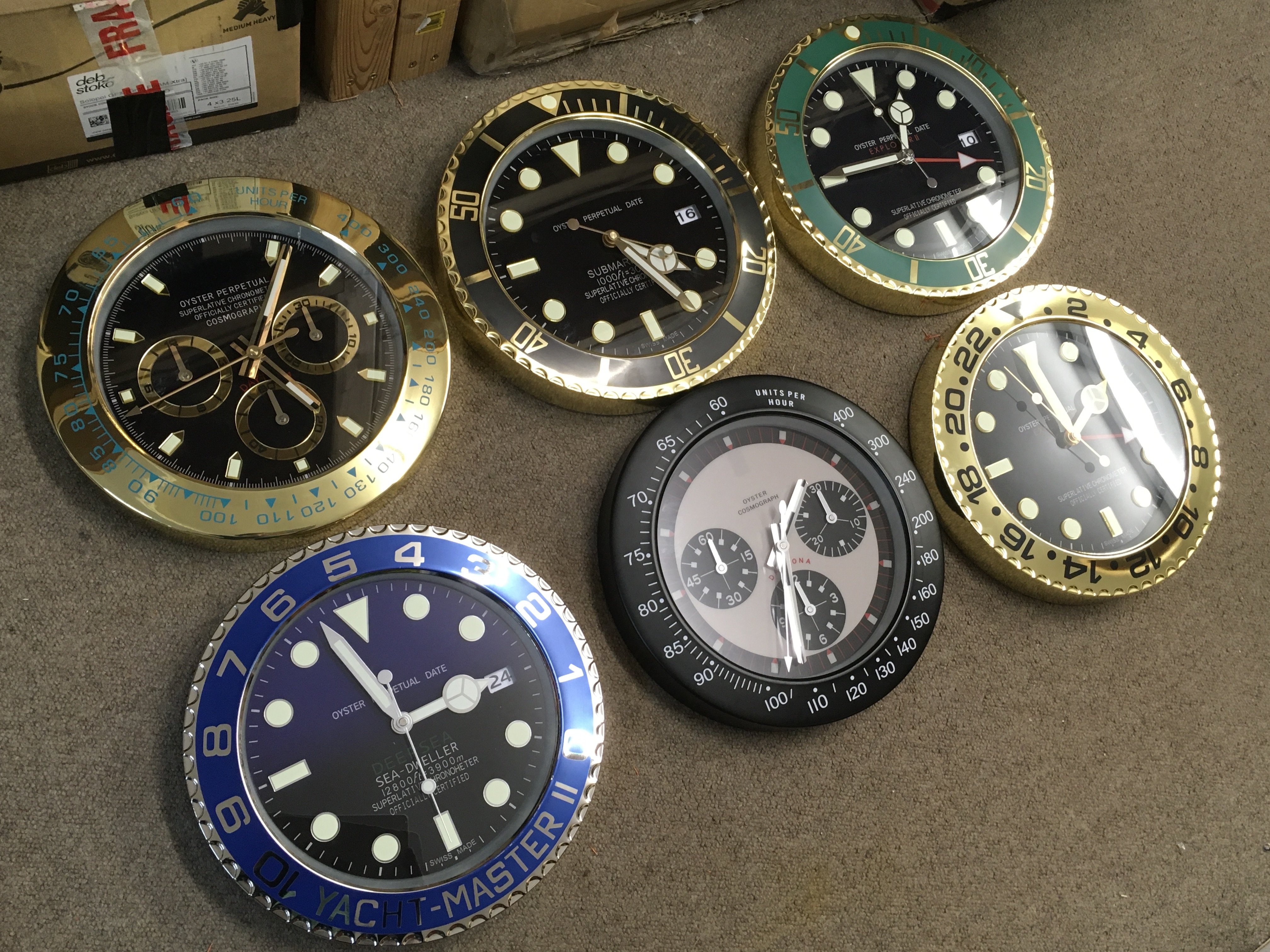 Six Rolex style battery operated novelty wall clocks . 34cm wide approximately