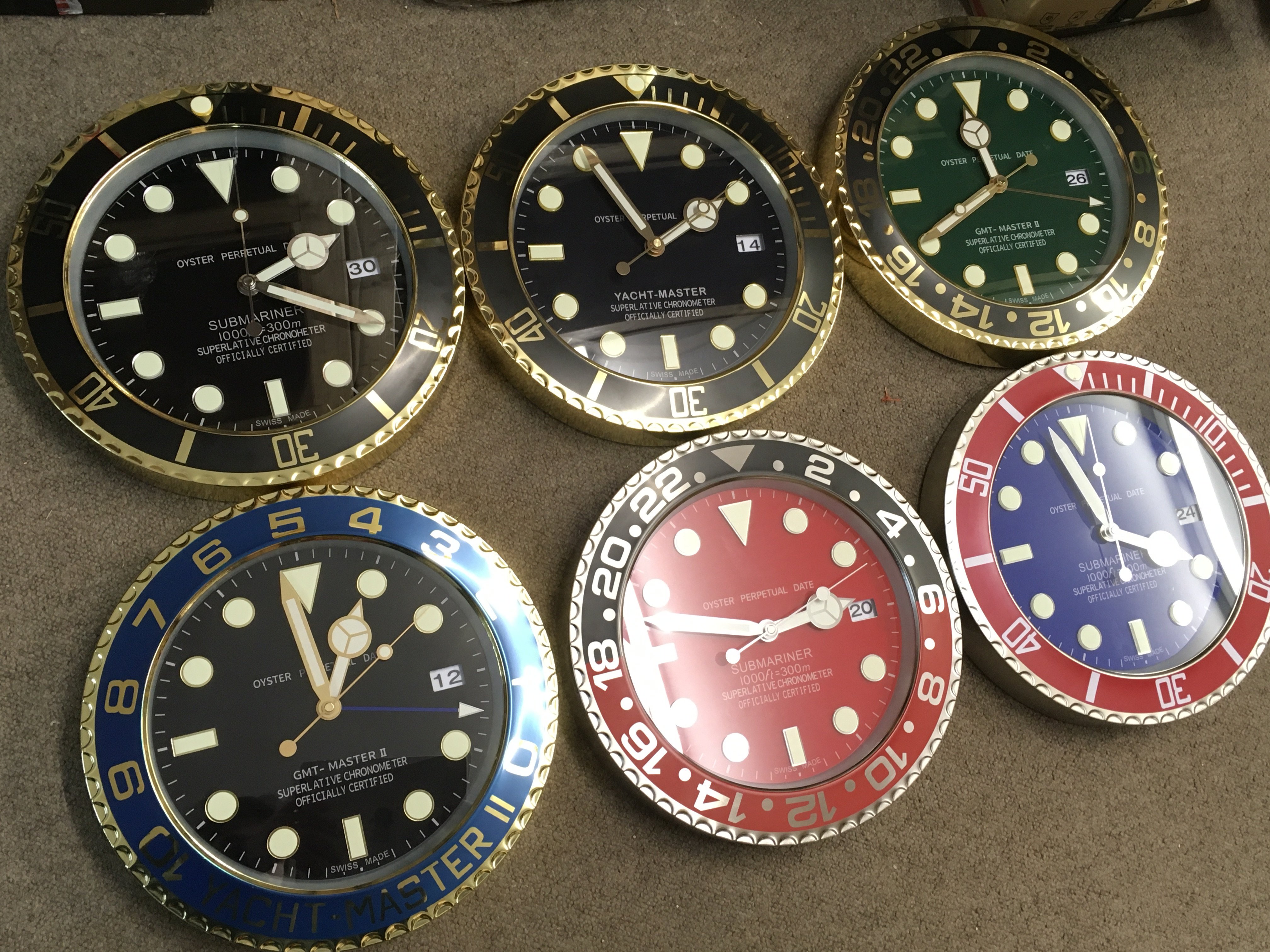Six Rolex style battery operated novelty wall clocks . 34cm wide approximately
