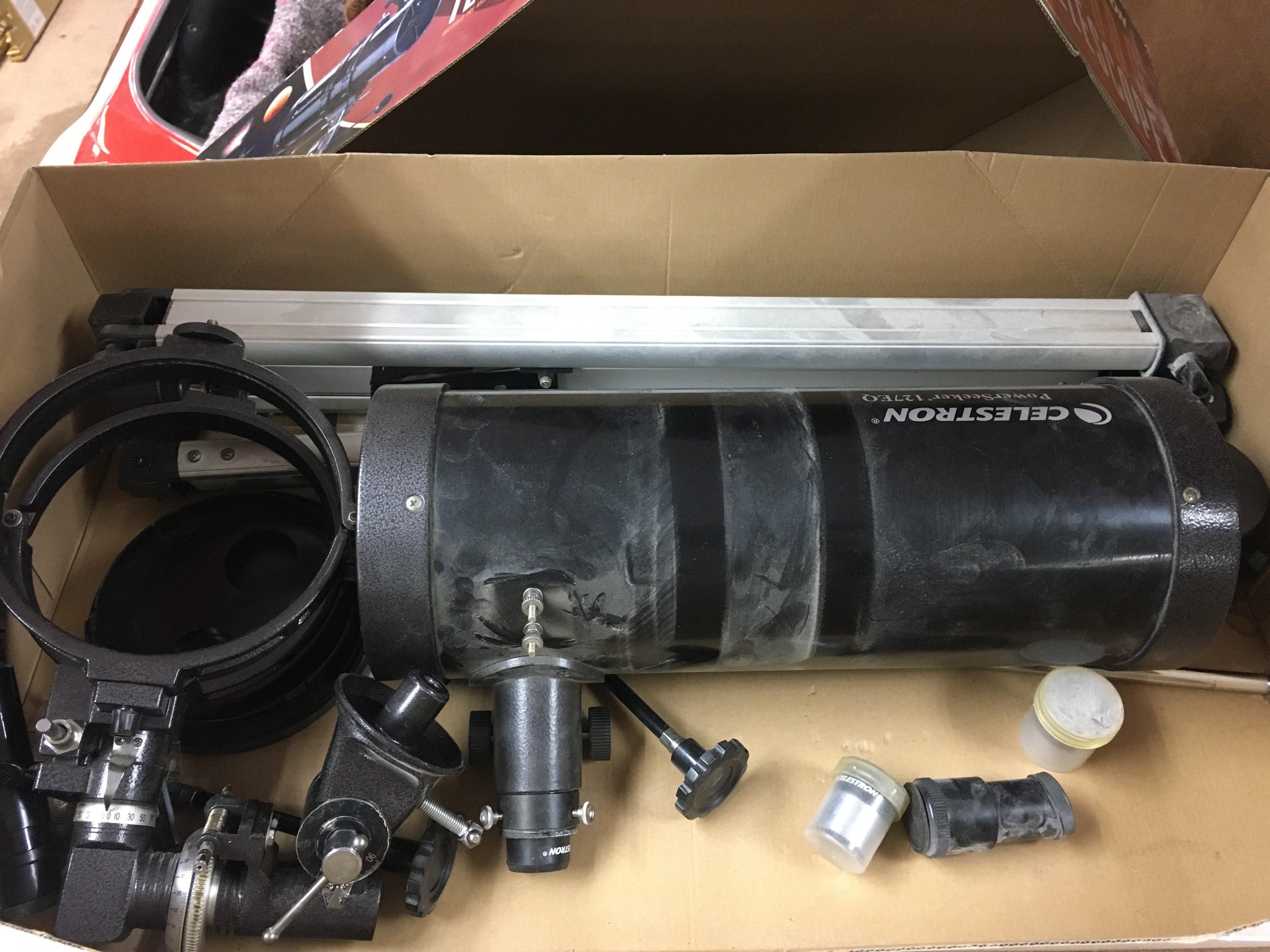 A celestron ps1000 telescope with stand and other attachments.