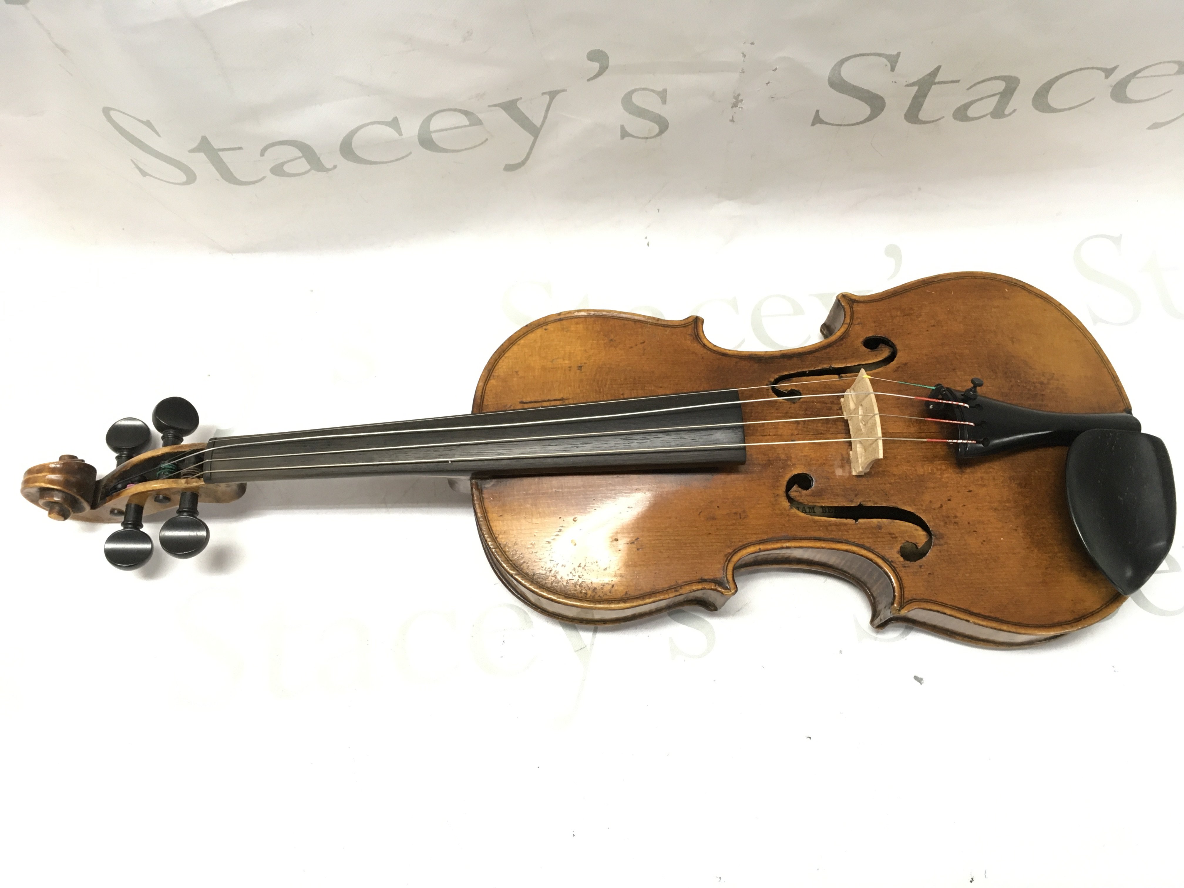 A William Beale 1840 Violin and bow in a fitted case . An interesting antique violin possibly 19th century by William Beale Manchester dated 1840 but may well be a German factory instrument , as a copy of the English, labelled inside the body. This lot cannot be posted