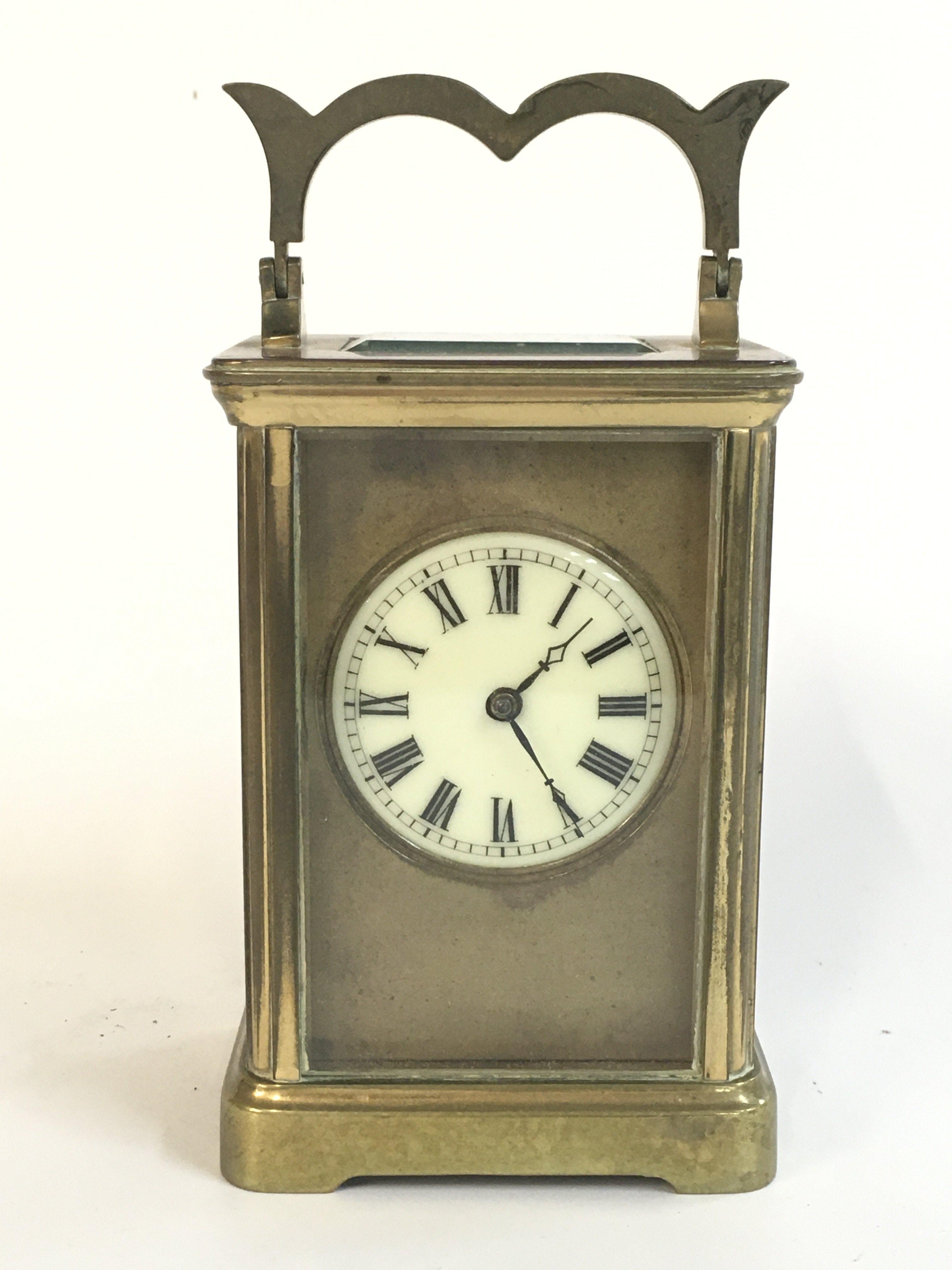 A brass clock , with key , seen working . Dimensions 11cm tall , 7.5cm wide. This lot cannot be posted