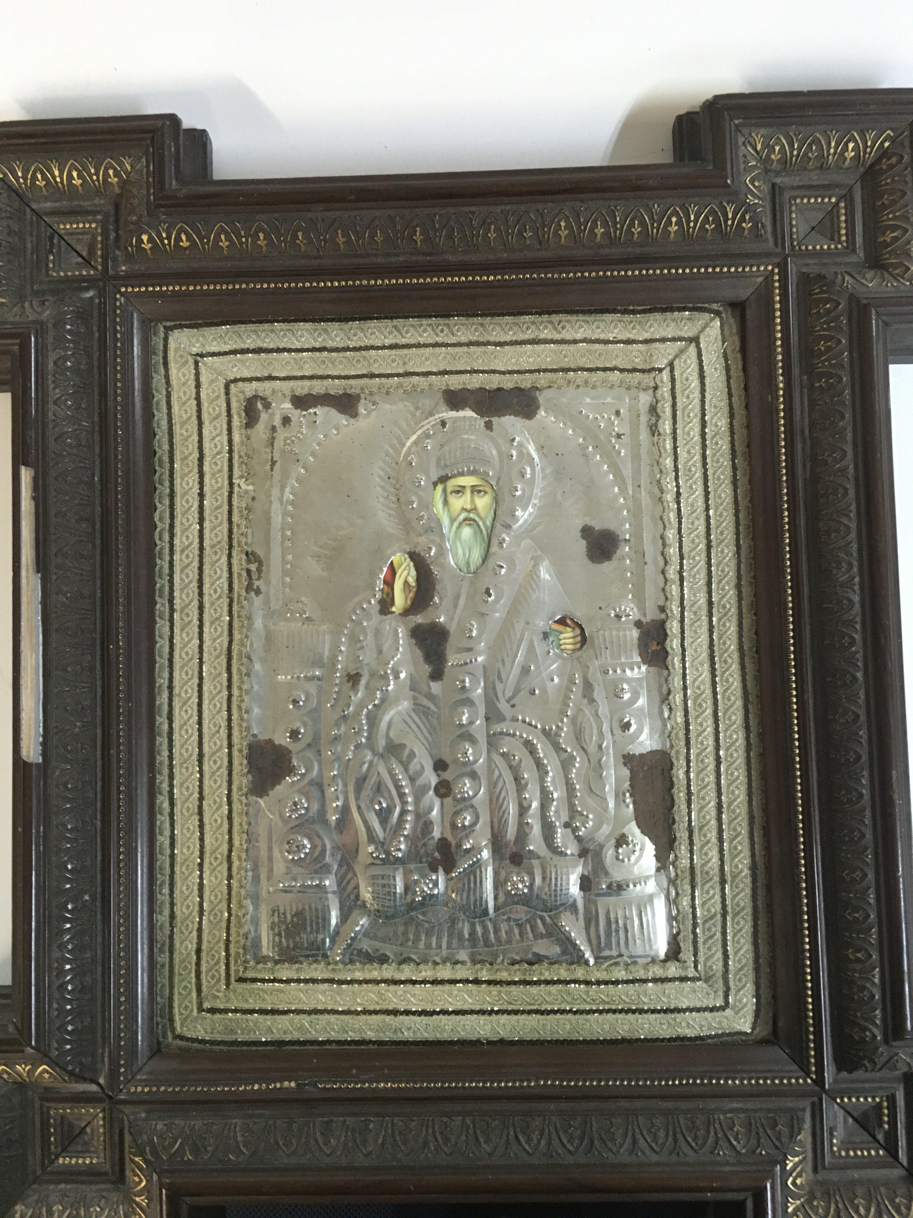 A Russian Icon on wood with a silver background . frame size 40x46cm.