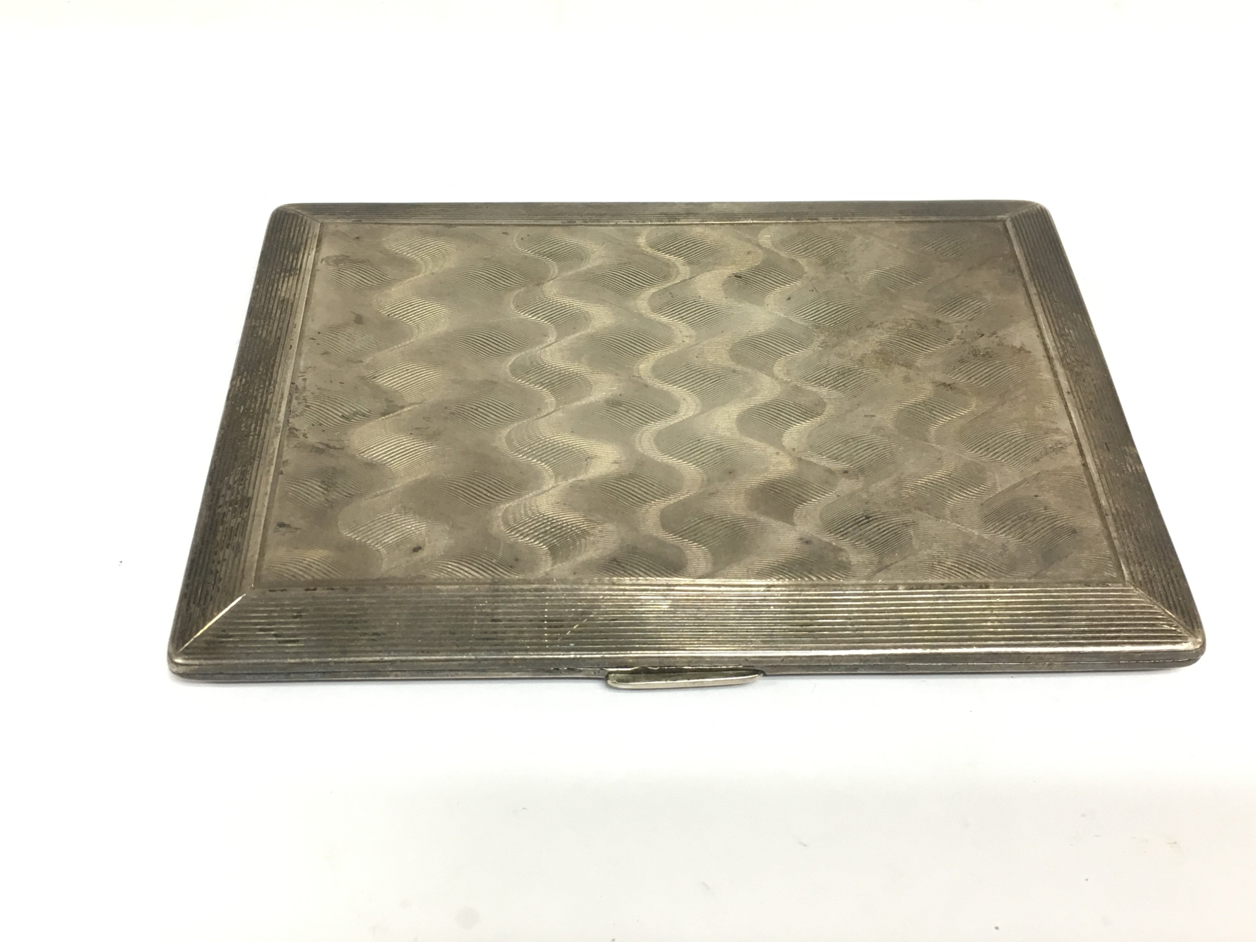 A silver cigarette case with engine turned decoration, Birmingham hallmarks. Shipping category A.