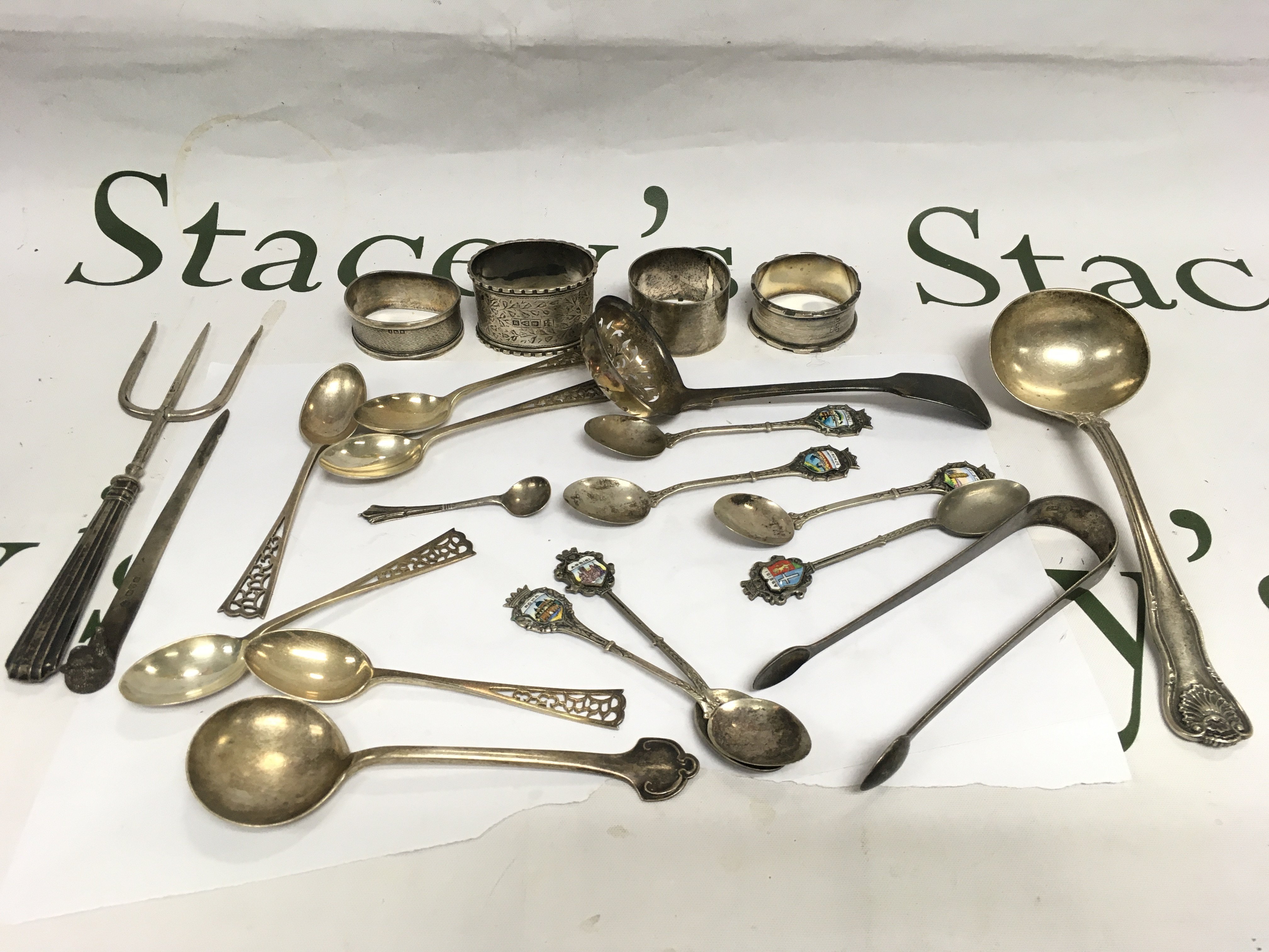 A collection of silver cutlery and napkin rings. Shipping category B.