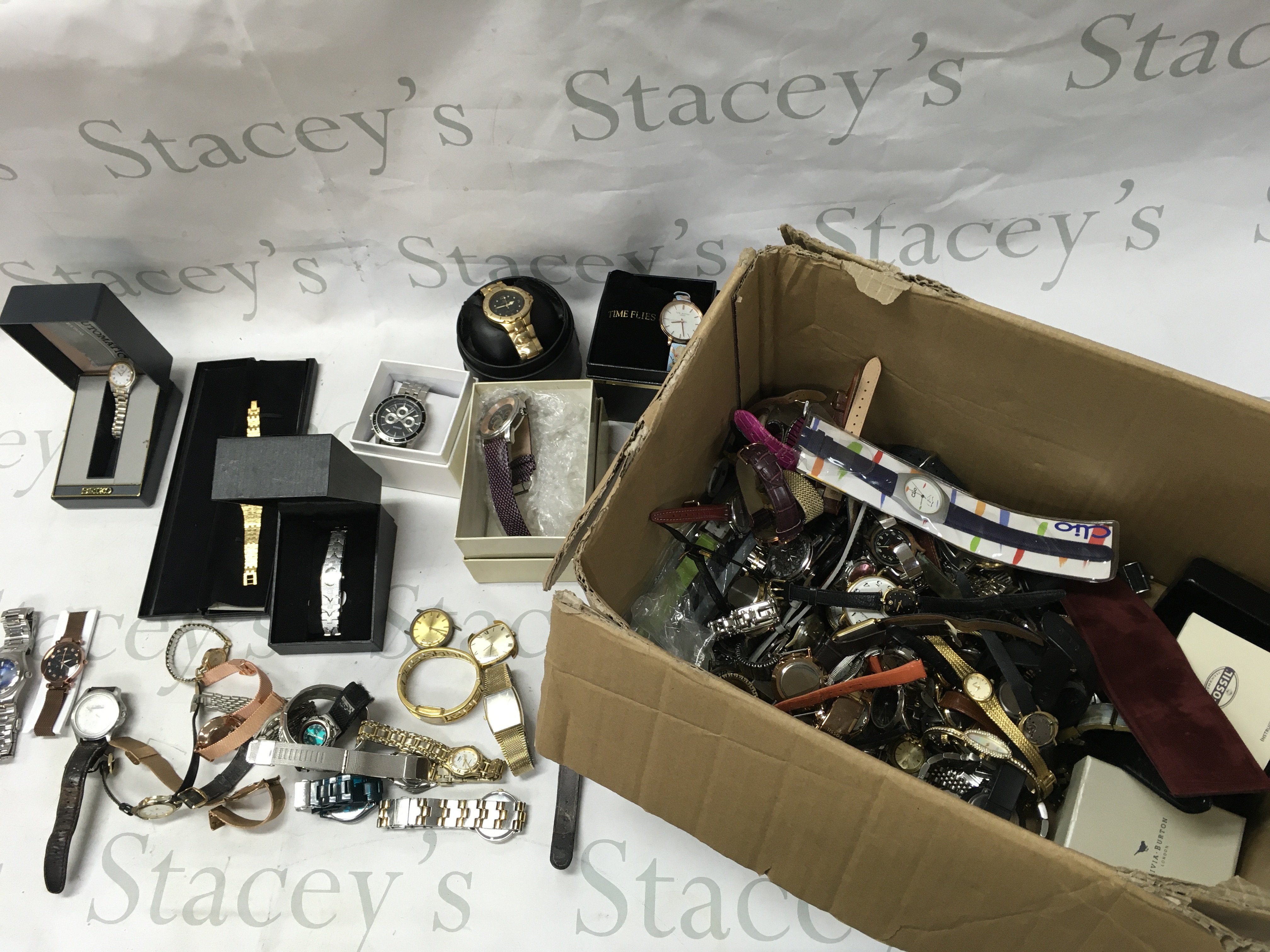 A large box of mixed watches including Ted baker Fossil etc Postage B