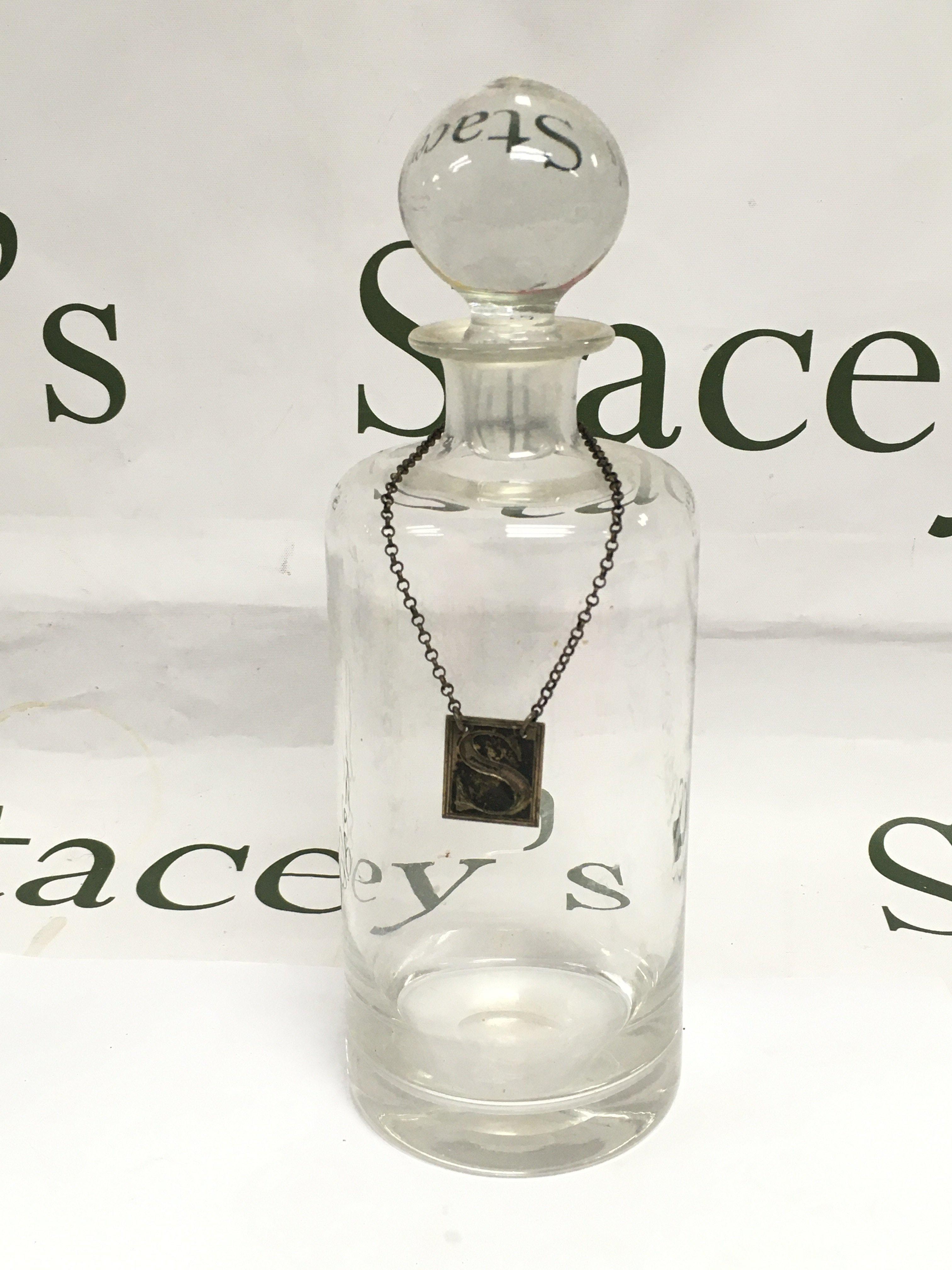 A glass wine decanter with a Georgian silver sherry label. Shipping category D.