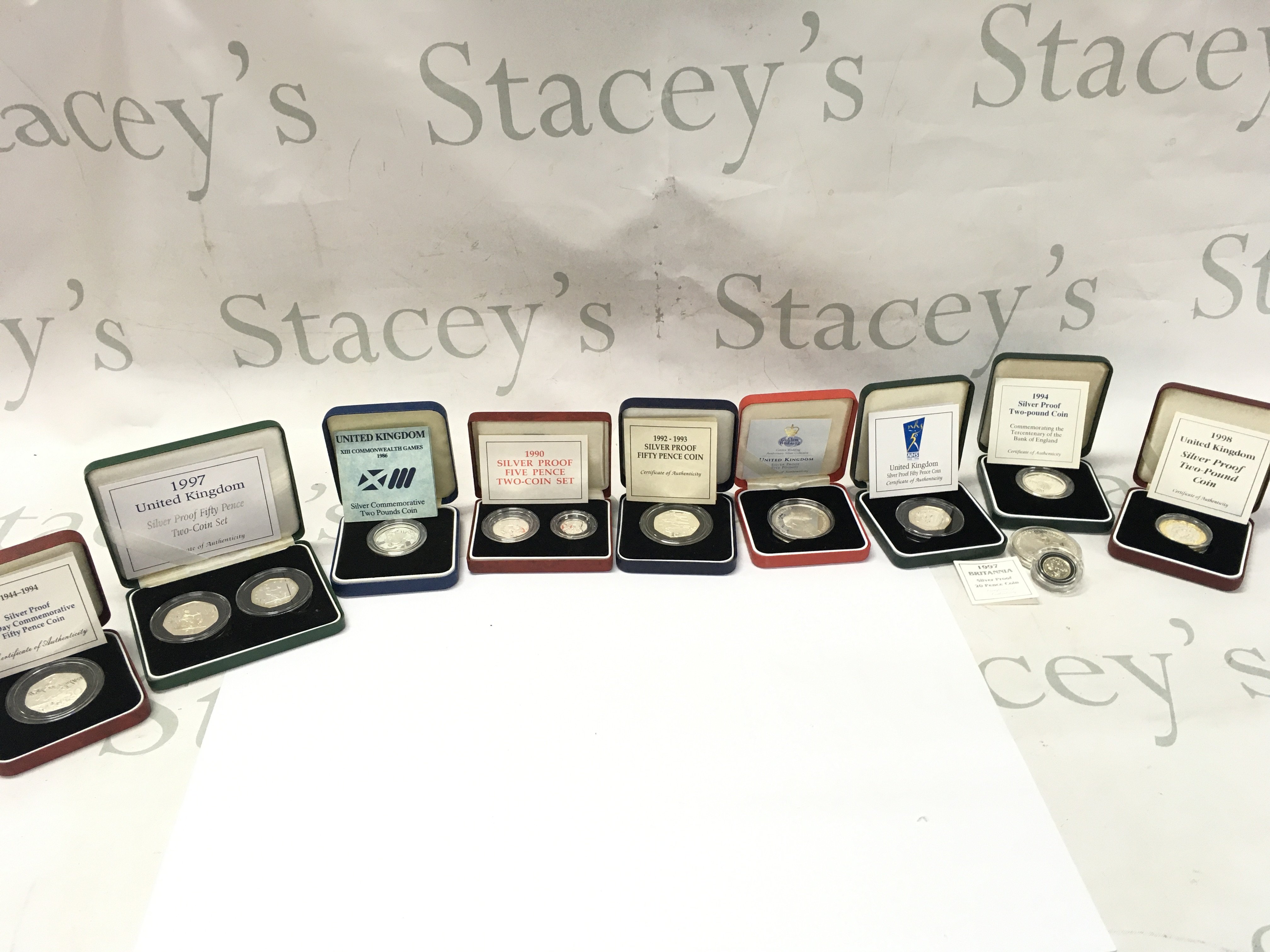 A collective lot of silver coins including silver proof fifty pence set. Postage B