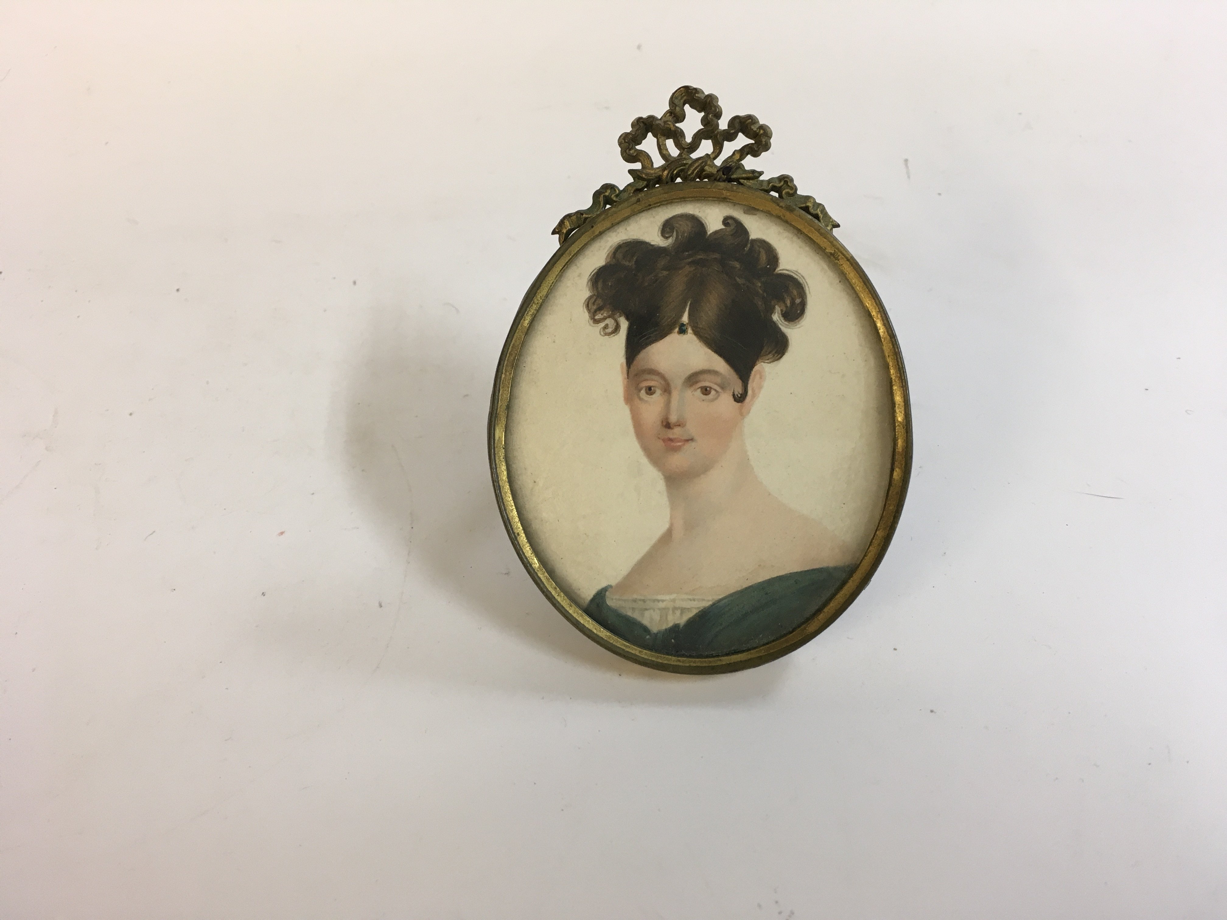 An oval portrait miniature of a lady circa 1790-1800