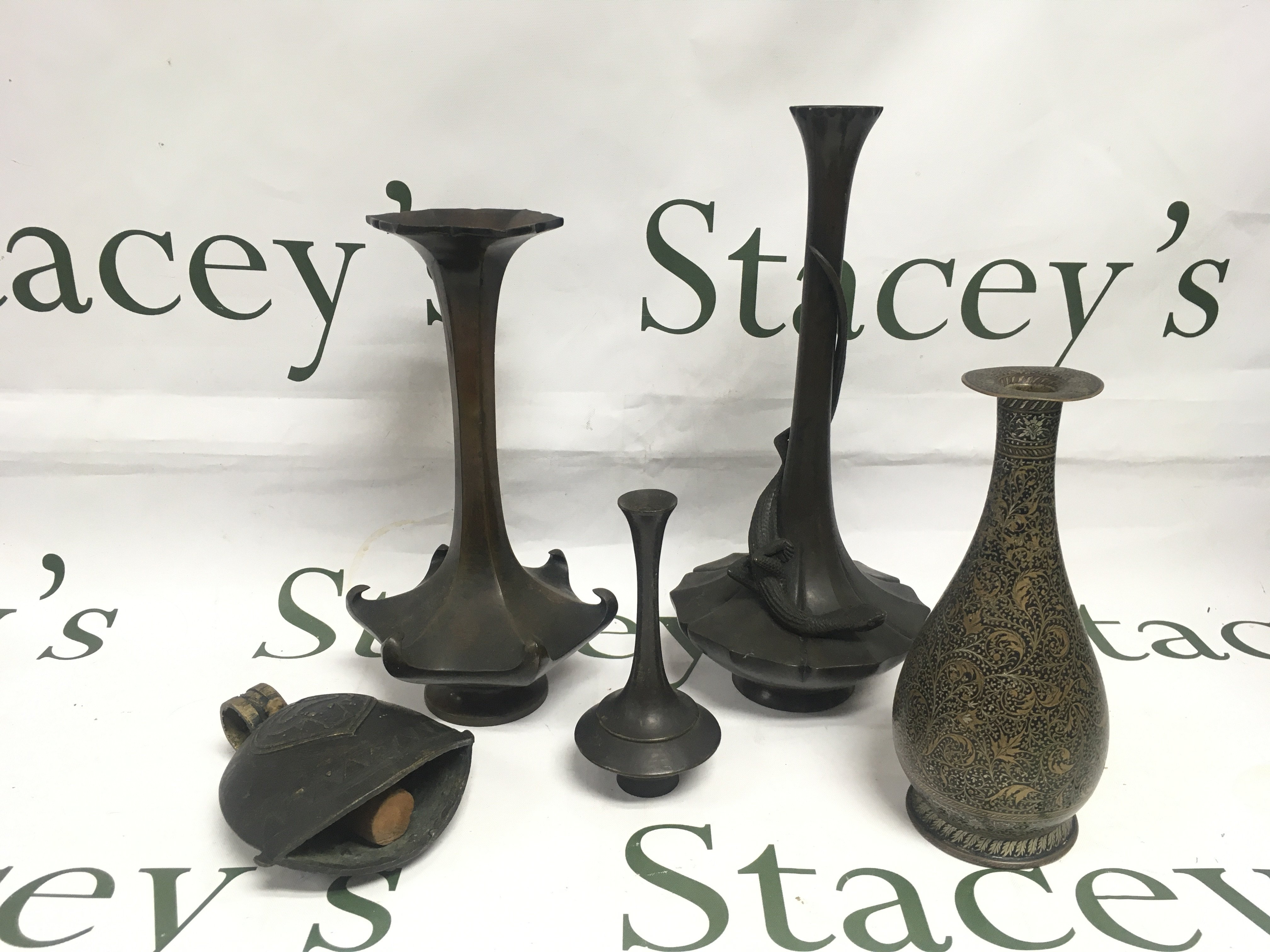 Four small bronze bud vases and a bell. Shipping category B.