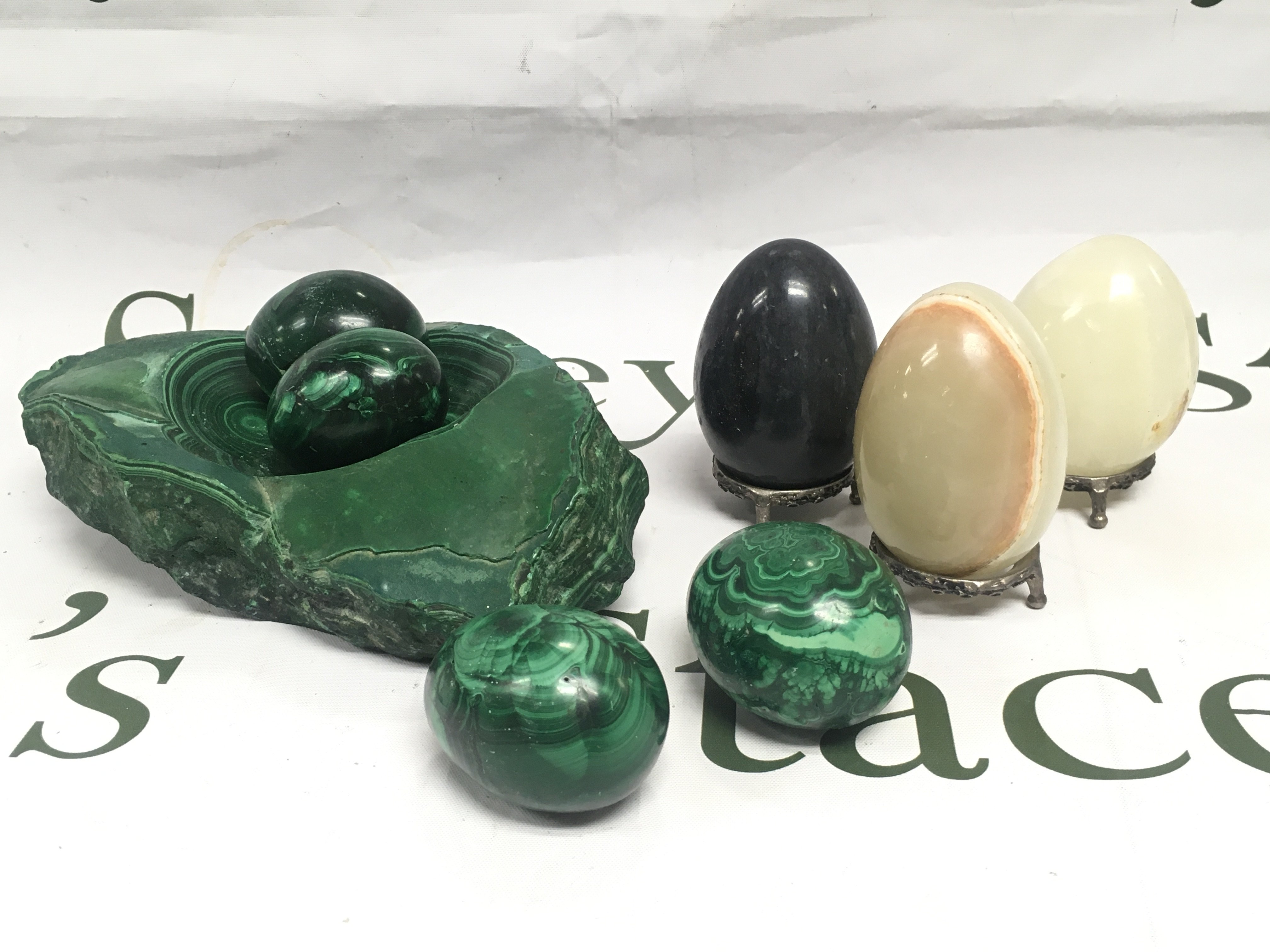 A small collection of green onyx and marble eggs. Shipping category B.