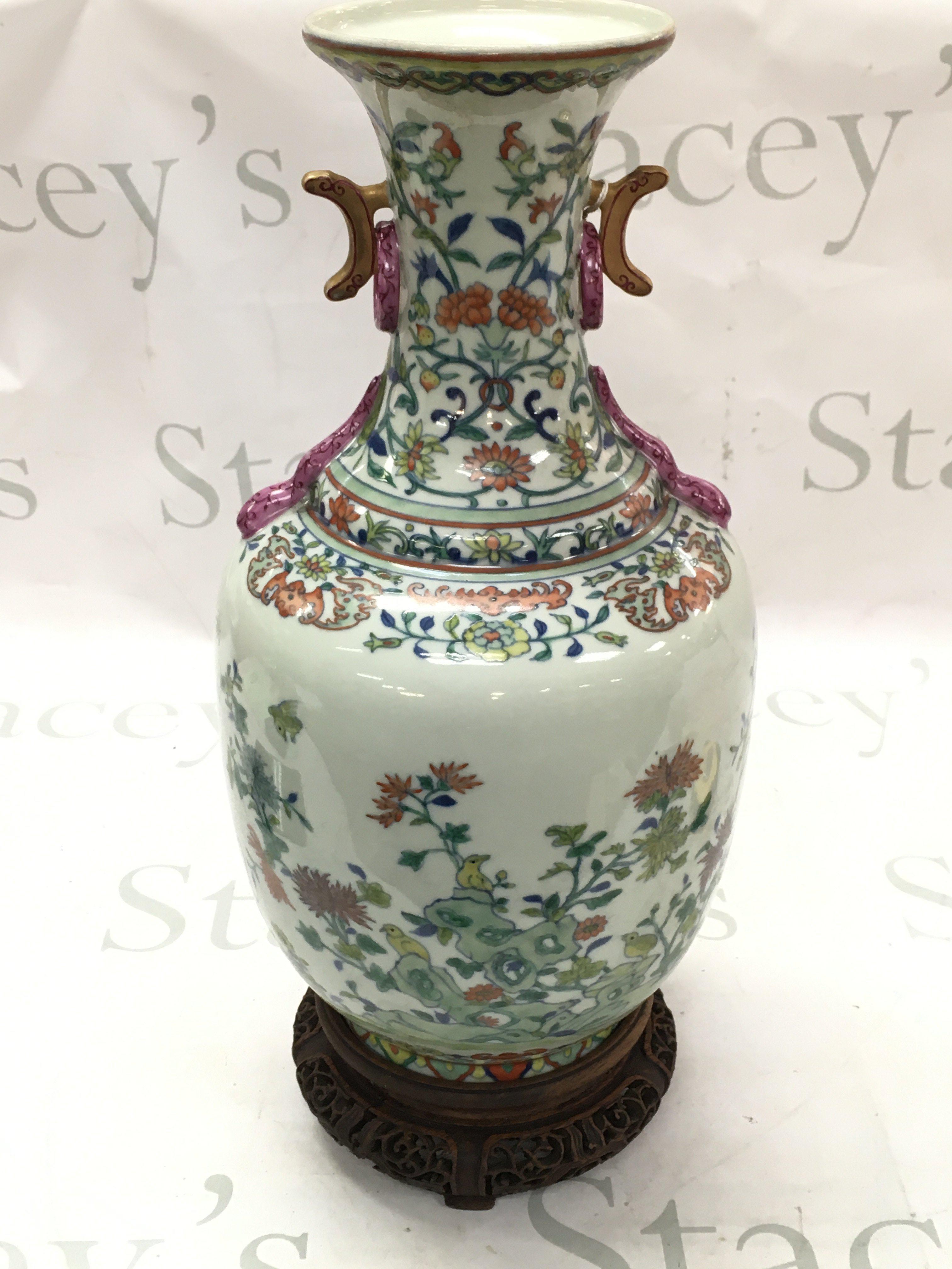 A Chinese porcelain celadon-glazed baluster vase with intricate designs of flowers, foliage, and birds. Blue six character mark to base. 34.5cm tall approximately. This lot cannot be posted