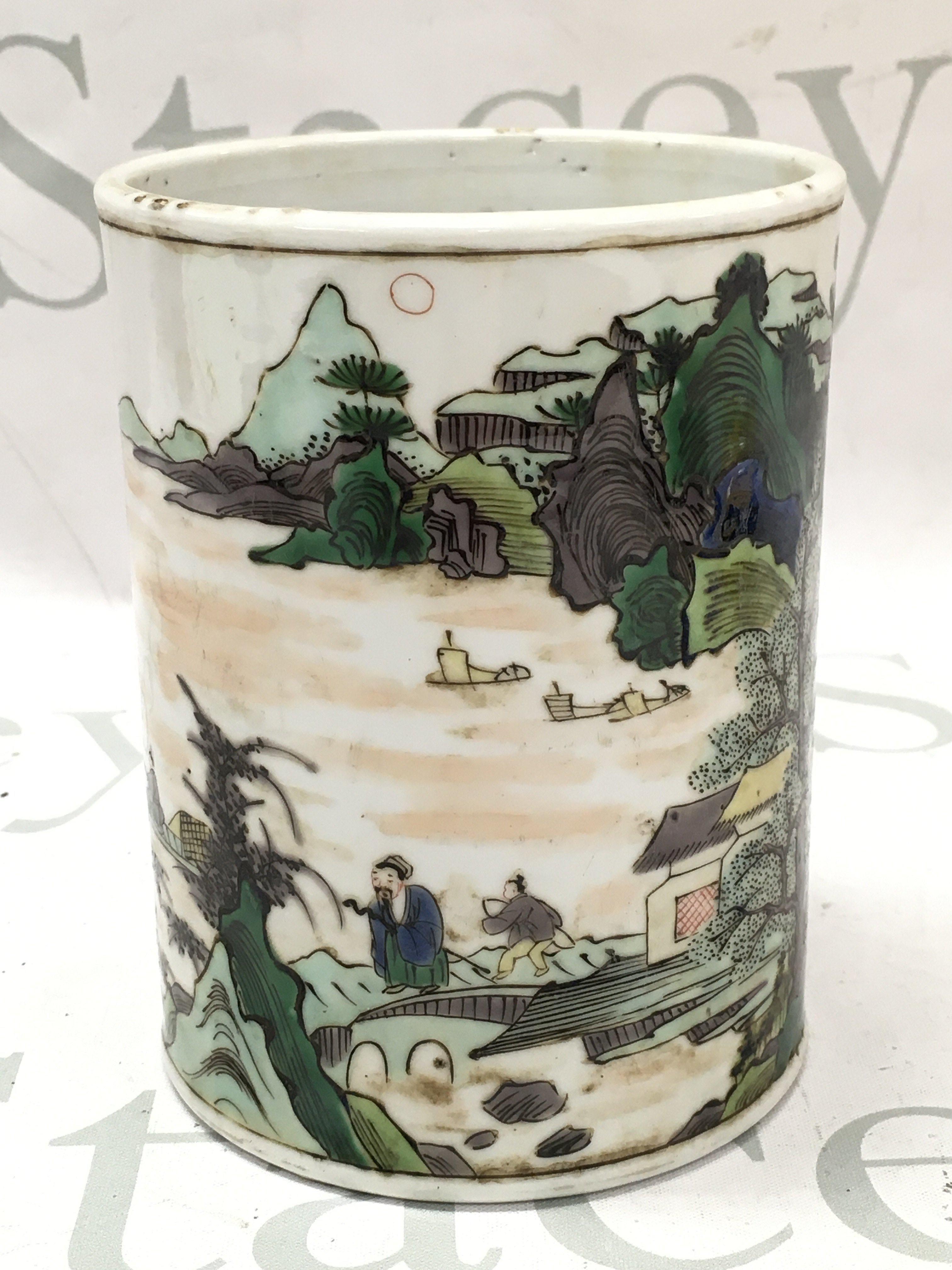 A Chinese famille verte brush pot , one side featuring a river temple scene and the other with Chinese characters. Dimensions 13.5cm tall 10.5cm wide . This lot cannot be posted