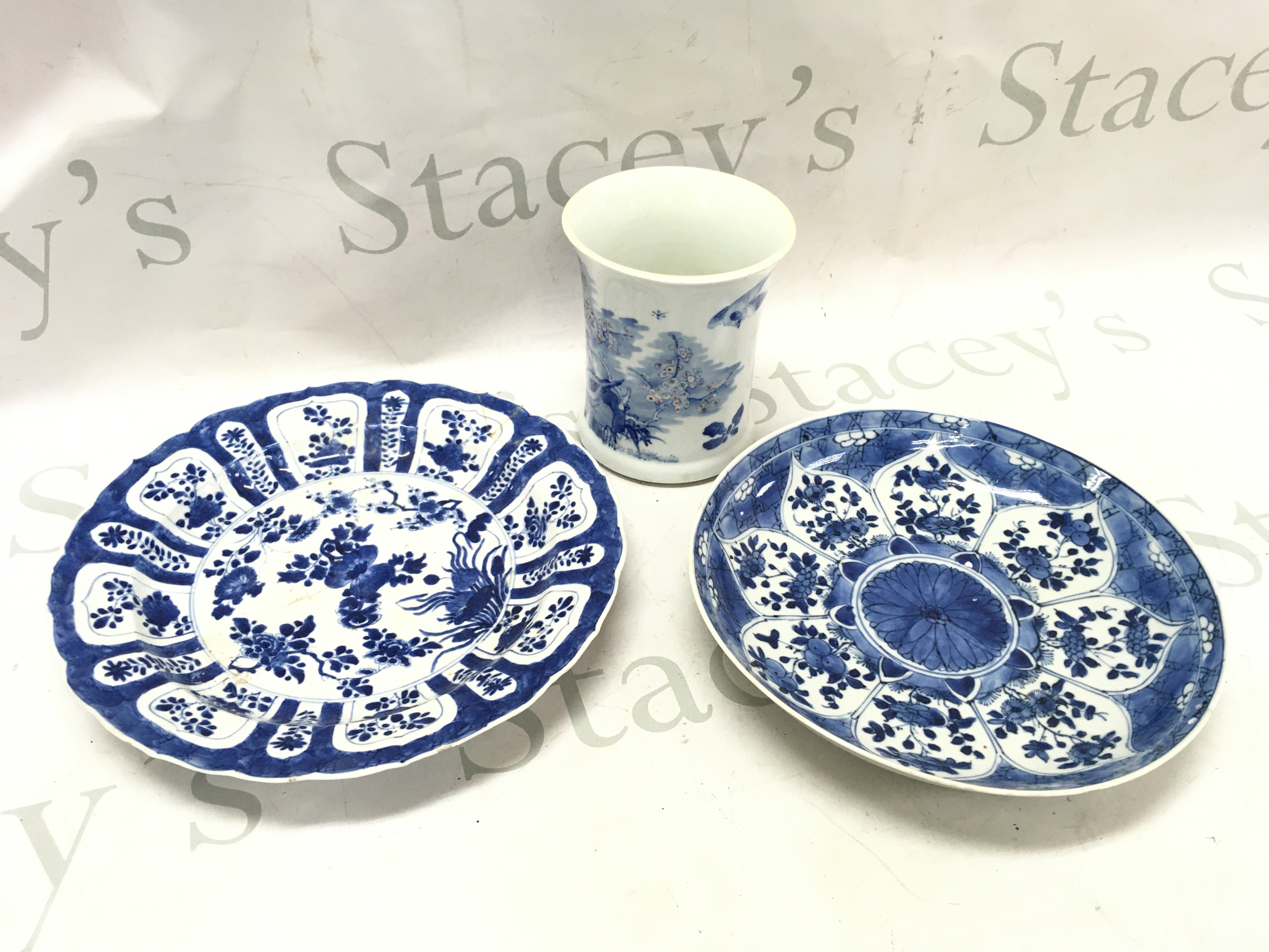 Chinese blue and white dishes with damage and restoration . (24 and 22cm wide approximately) and a small brush pot with bird and cherry blossom tree design (12.5cm tall) . This lot cannot be posted