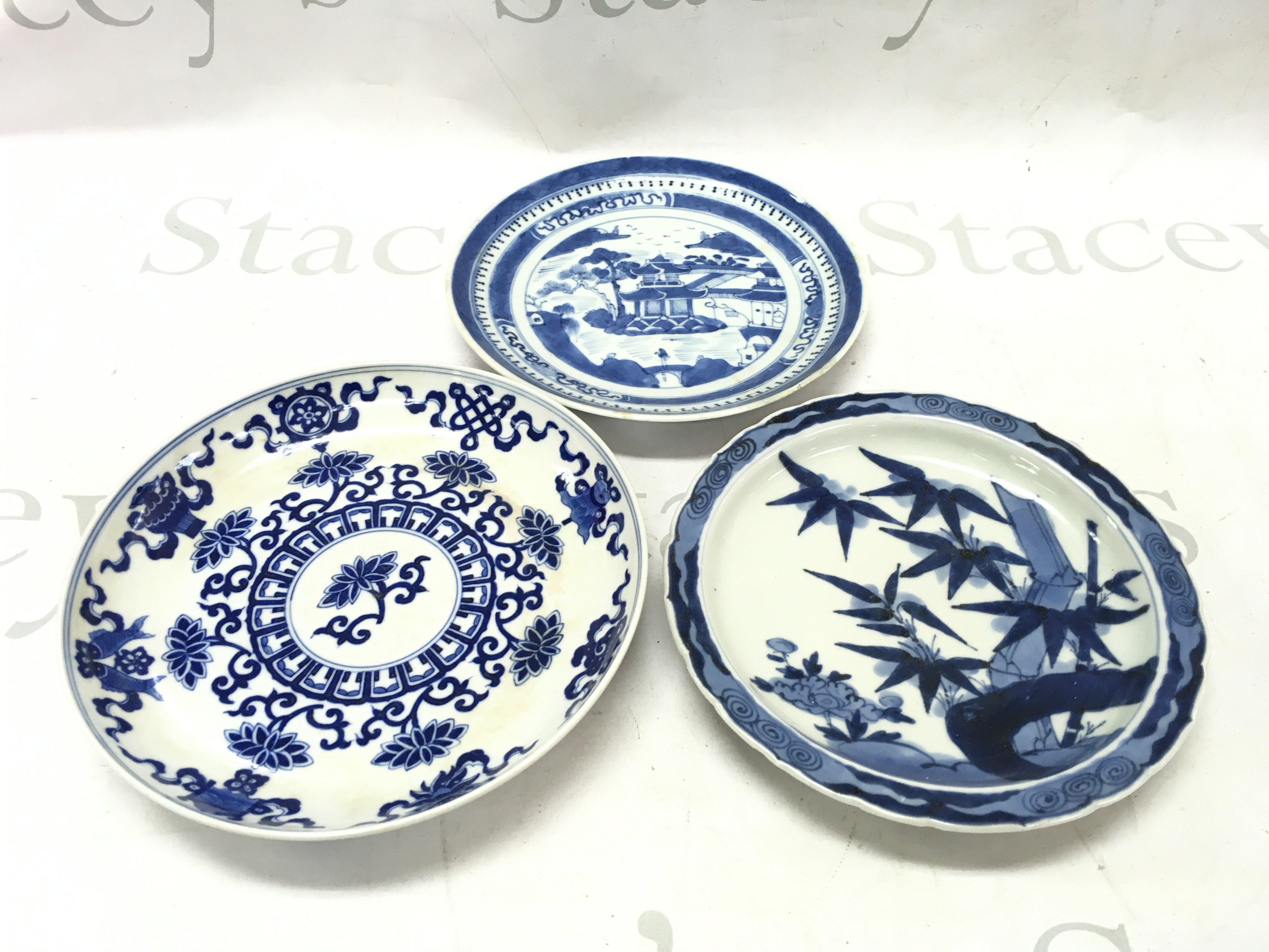 A Collection of Chinese blue and white dishes with floral and temple designs. Approximately 20cm wide. This lot cannot be posted