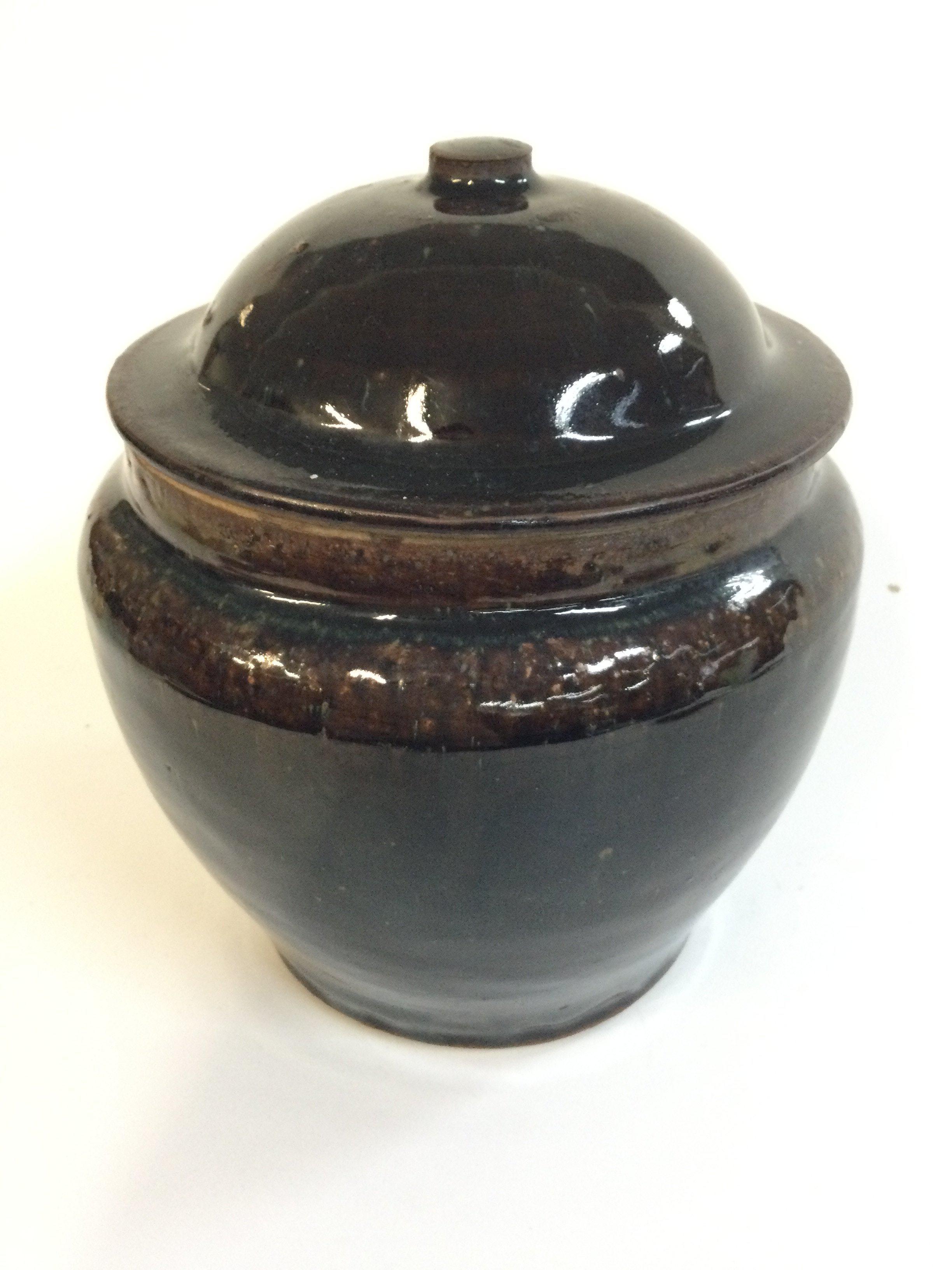 A Chinese tenmoku glaze lidded jar, 18cm tall approximately.