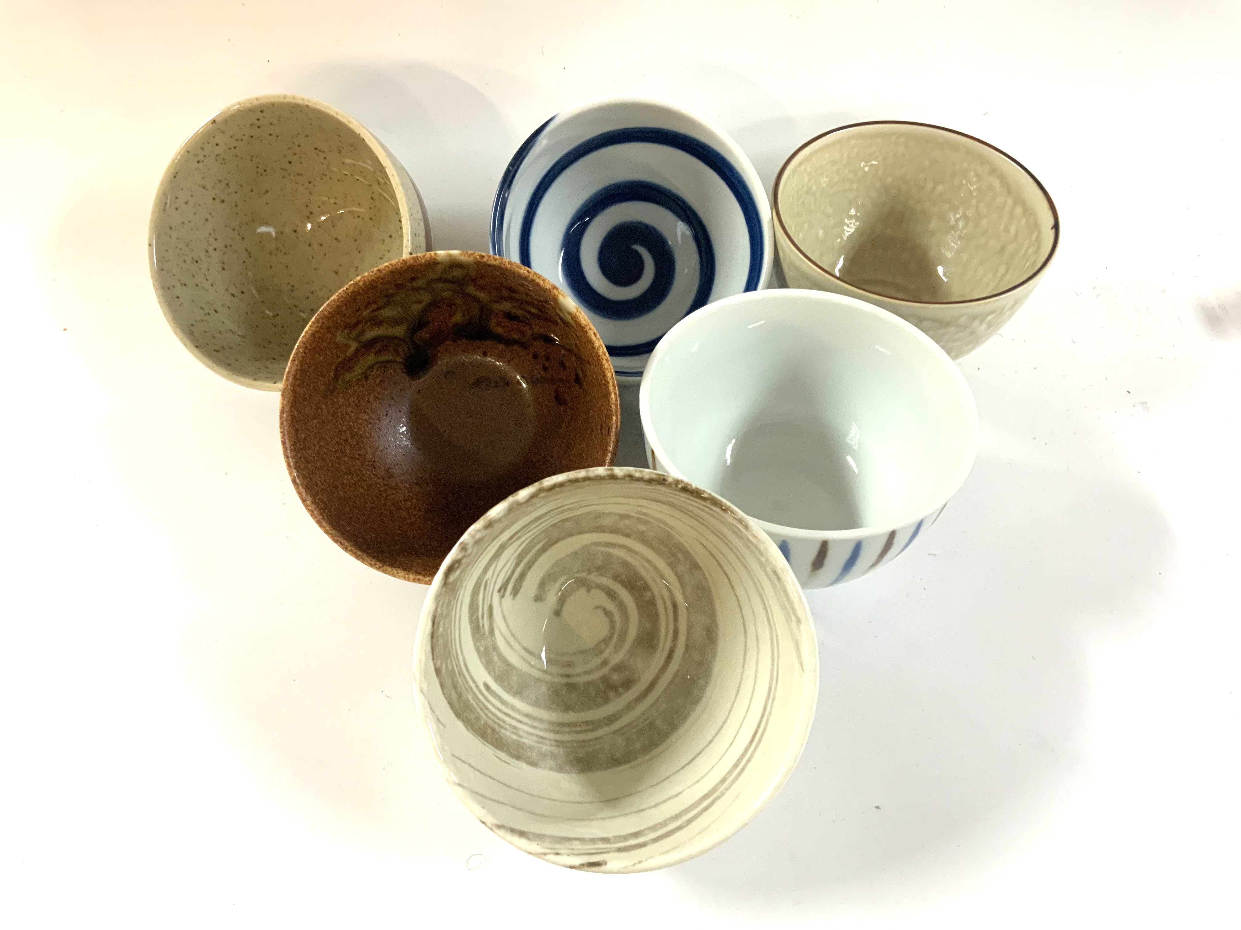 A boxed set of 6 Japanese tea bowls, various glazes.